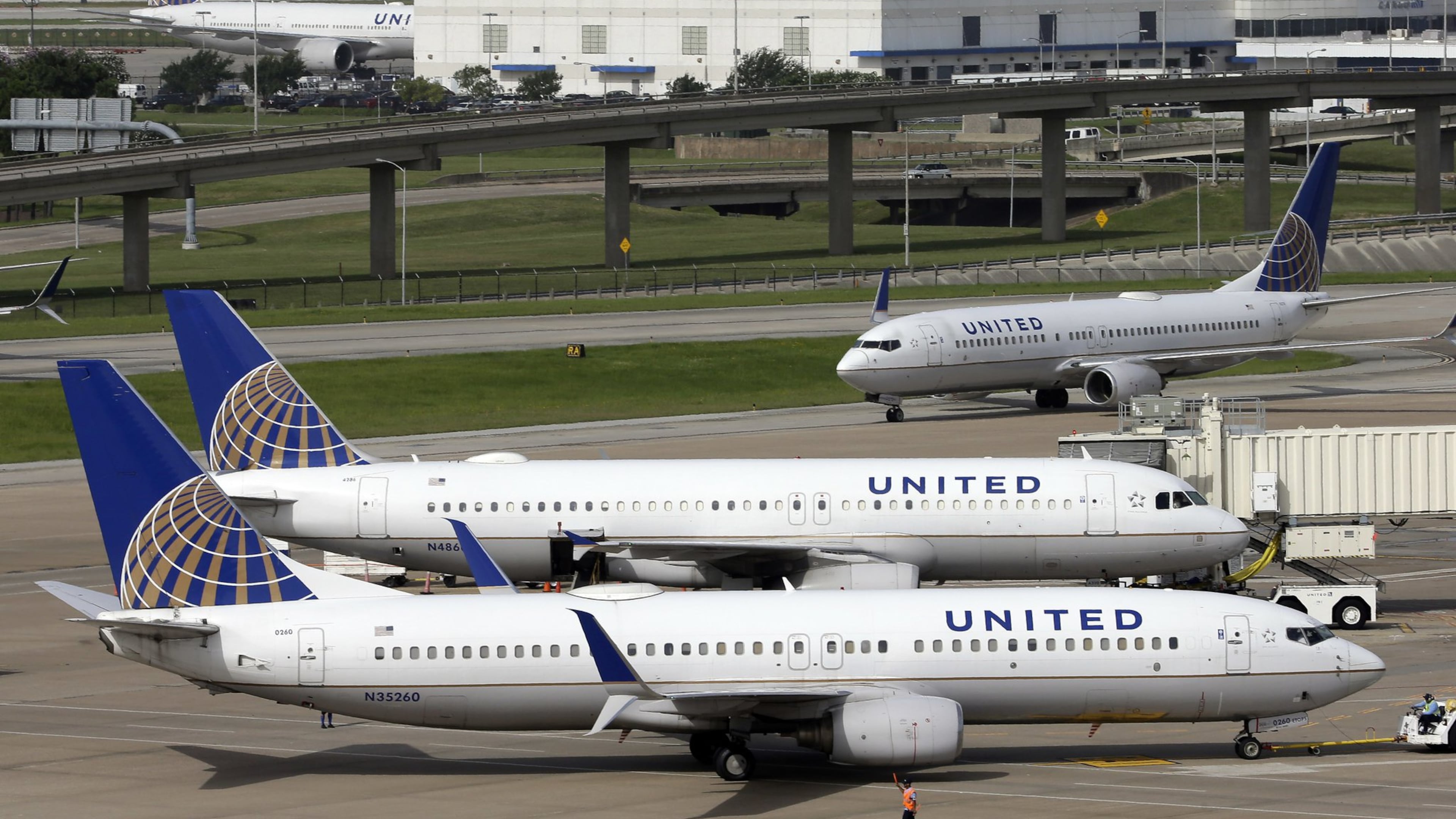 In this July 8, 2015, file photo, a United Airlines plane, front, is pushed back from a gate at George Bush Intercontinental Airport in Houston. (AP Photo/David J. Phillip, File)