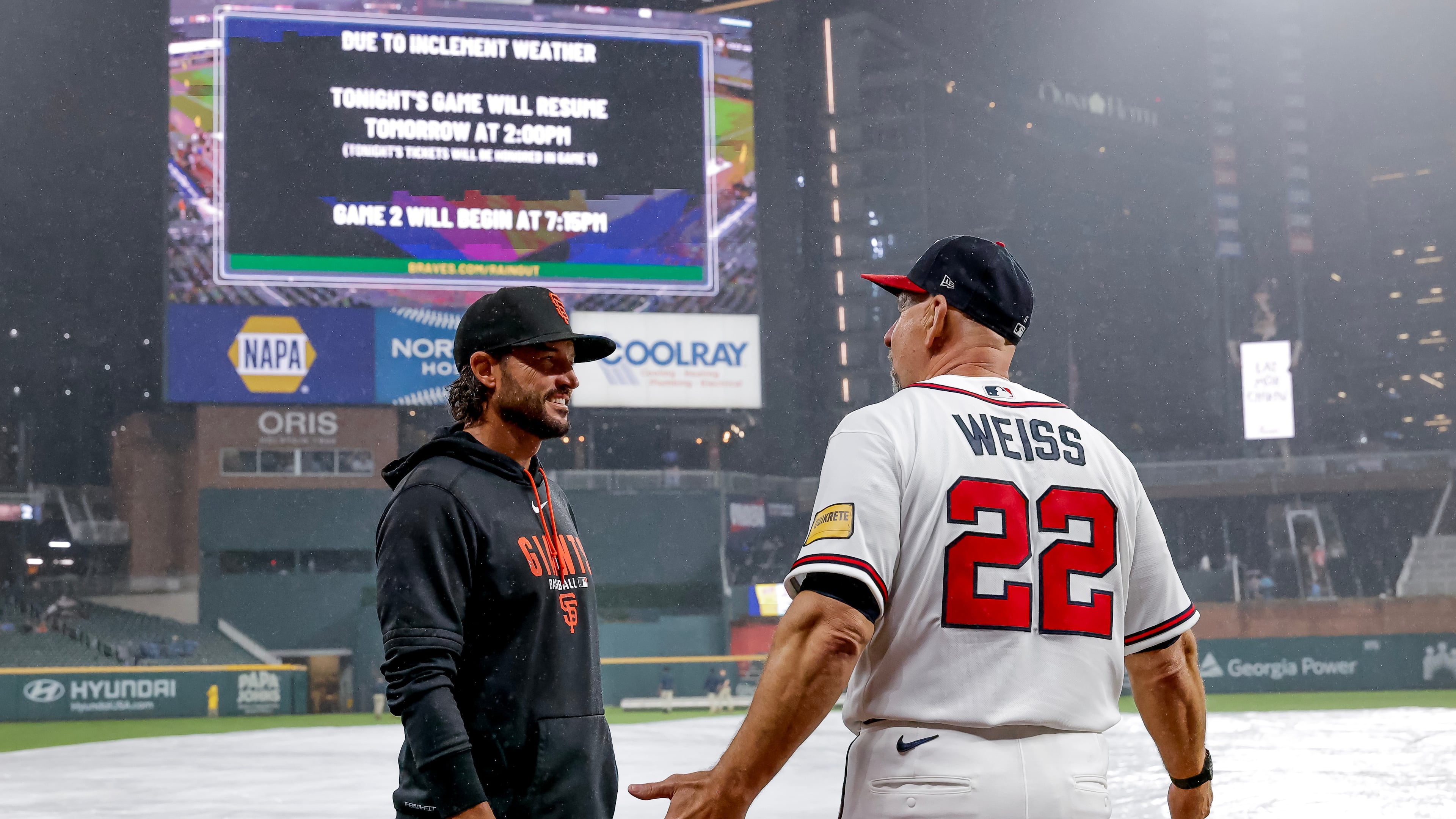 Giants manager Tony Vitello (left) speaks with Braves manager Walt Weiss after their game was suspended because of weather on Tuesday, June 16, 2026, in Atlanta. (Erik S. Lesser/AP)