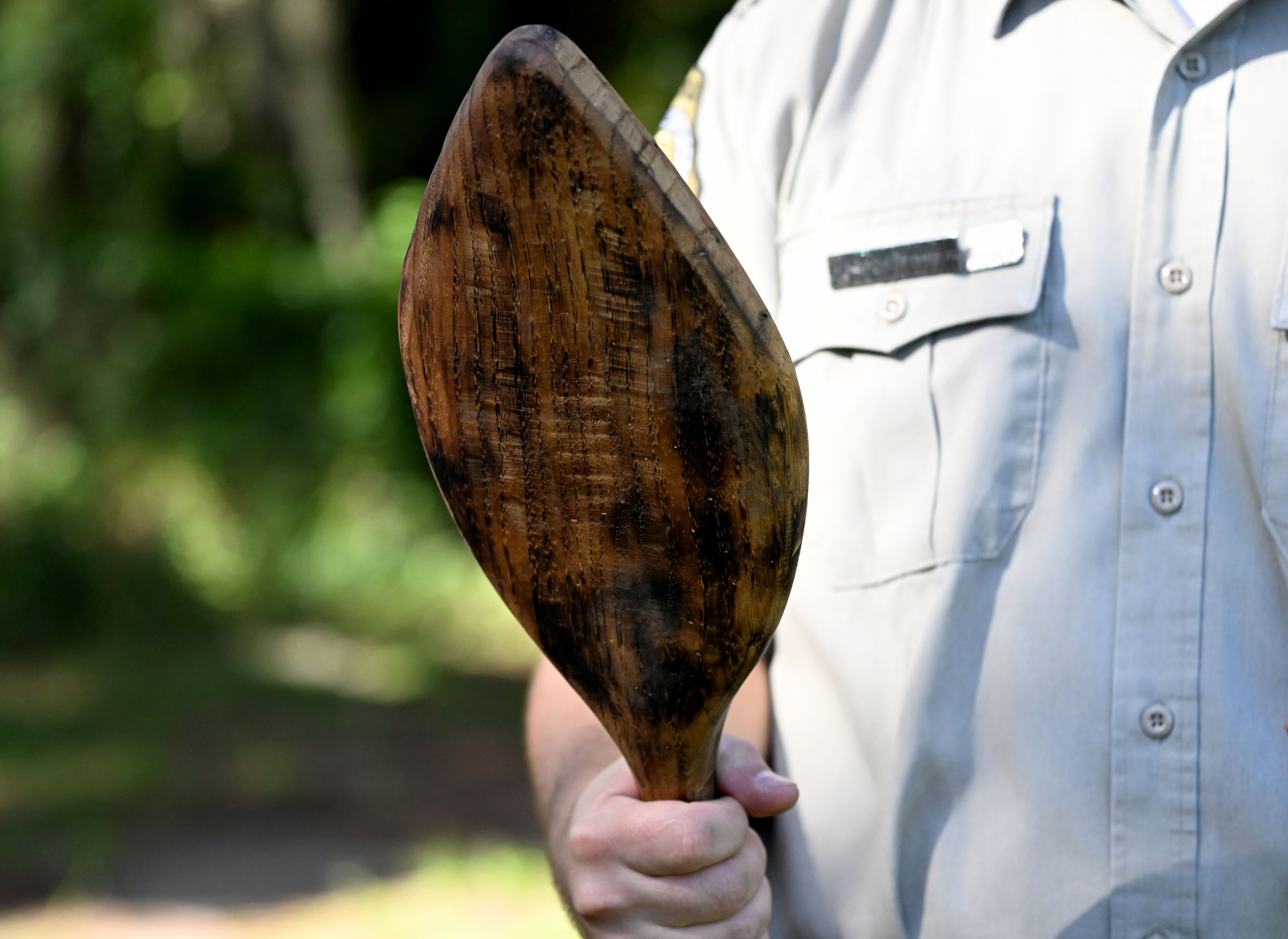 Michael Putman, site manager at Fort King George State Historic Site, holds a macana, a heavy wooden war club used by the Guale tribe. (Hyosub Shin/AJC)