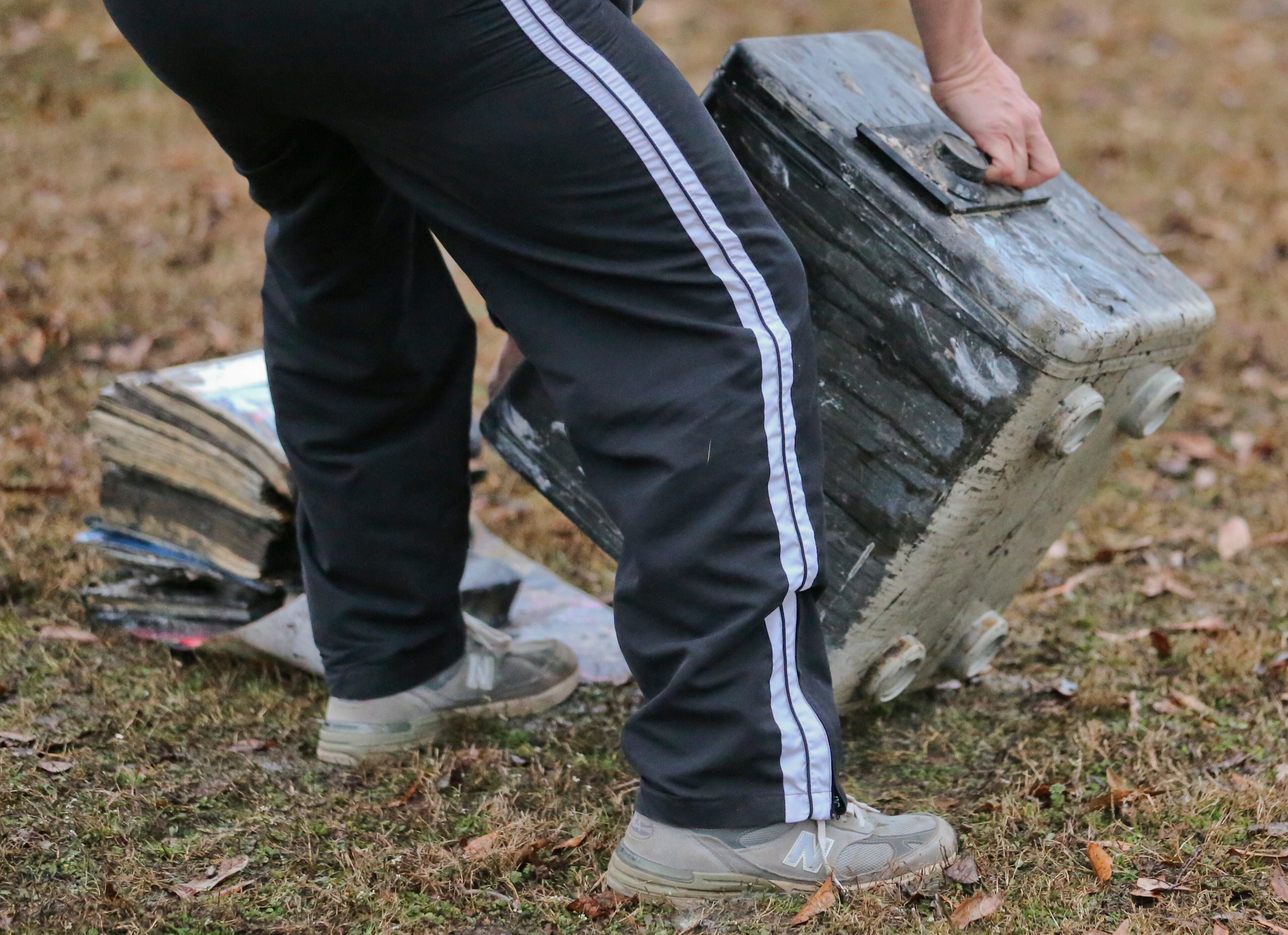 A man helps residents at a home on Morning Glory Lane to gather belongings. Thirteen people were displaced in a predawn fire that damaged four homes in a neighborhood near Lawrenceville.