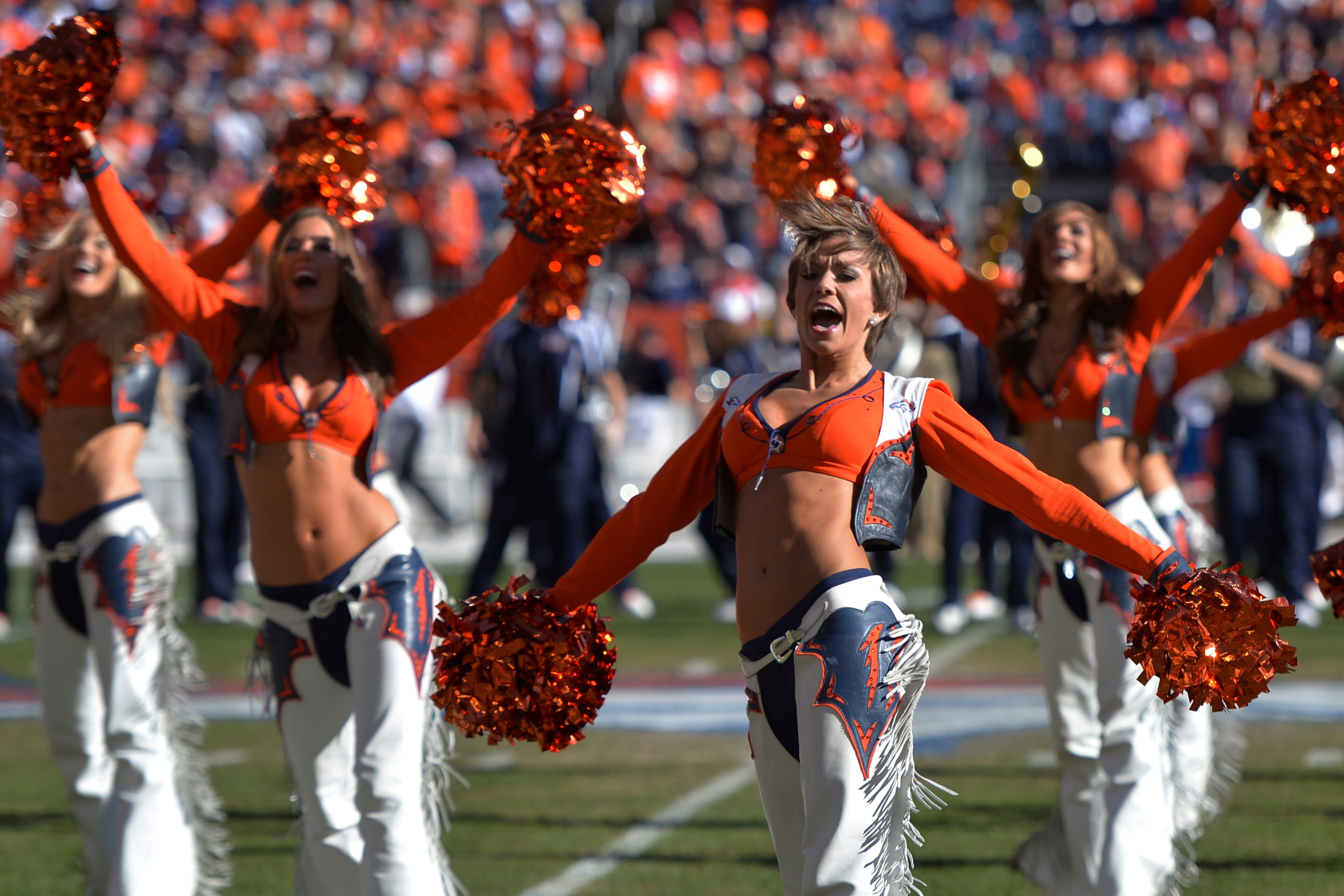 Broncos cheerleaders perform before the first half of an NFL football game between the Denver Broncos and the New England Patriots in Denver on Jan. 19, 2014.