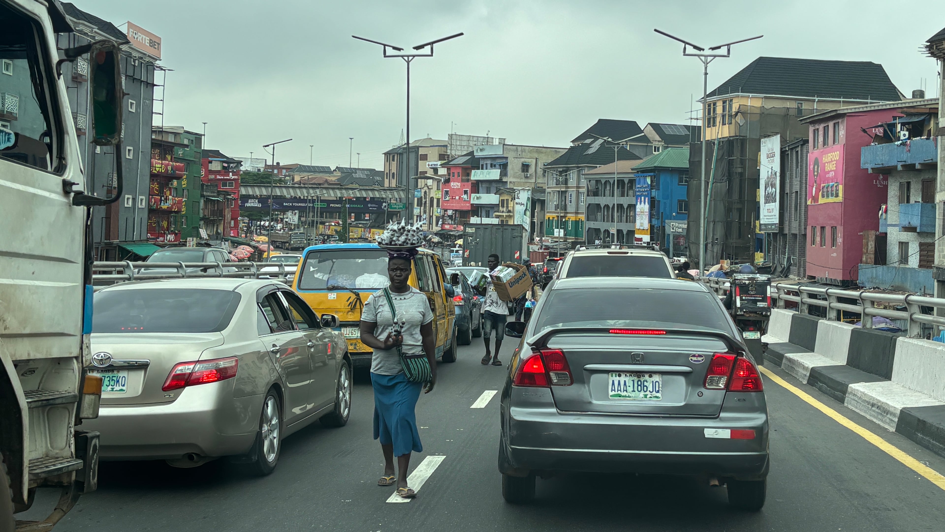 People sell their merchandise during rush hour traffic in Lagos, Nigeria, Tuesday, Aug. 18, 2026. (AP Photo/Sunday Alamba)