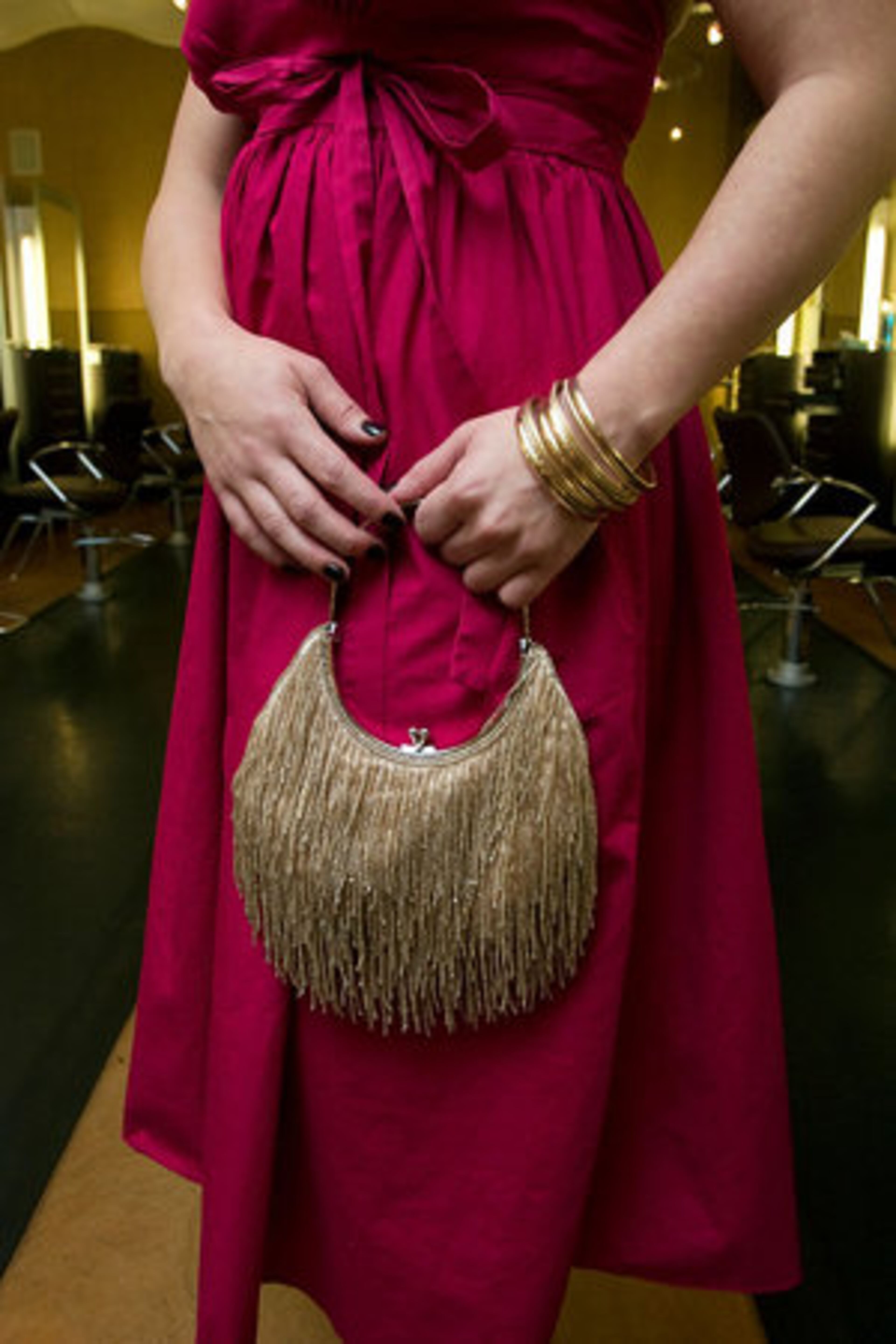 Here, McCarty wears her French Connection dress purchased at Marshall's for $15 and a beaded purse purchased for $15 at a thrift store in Minnesota.