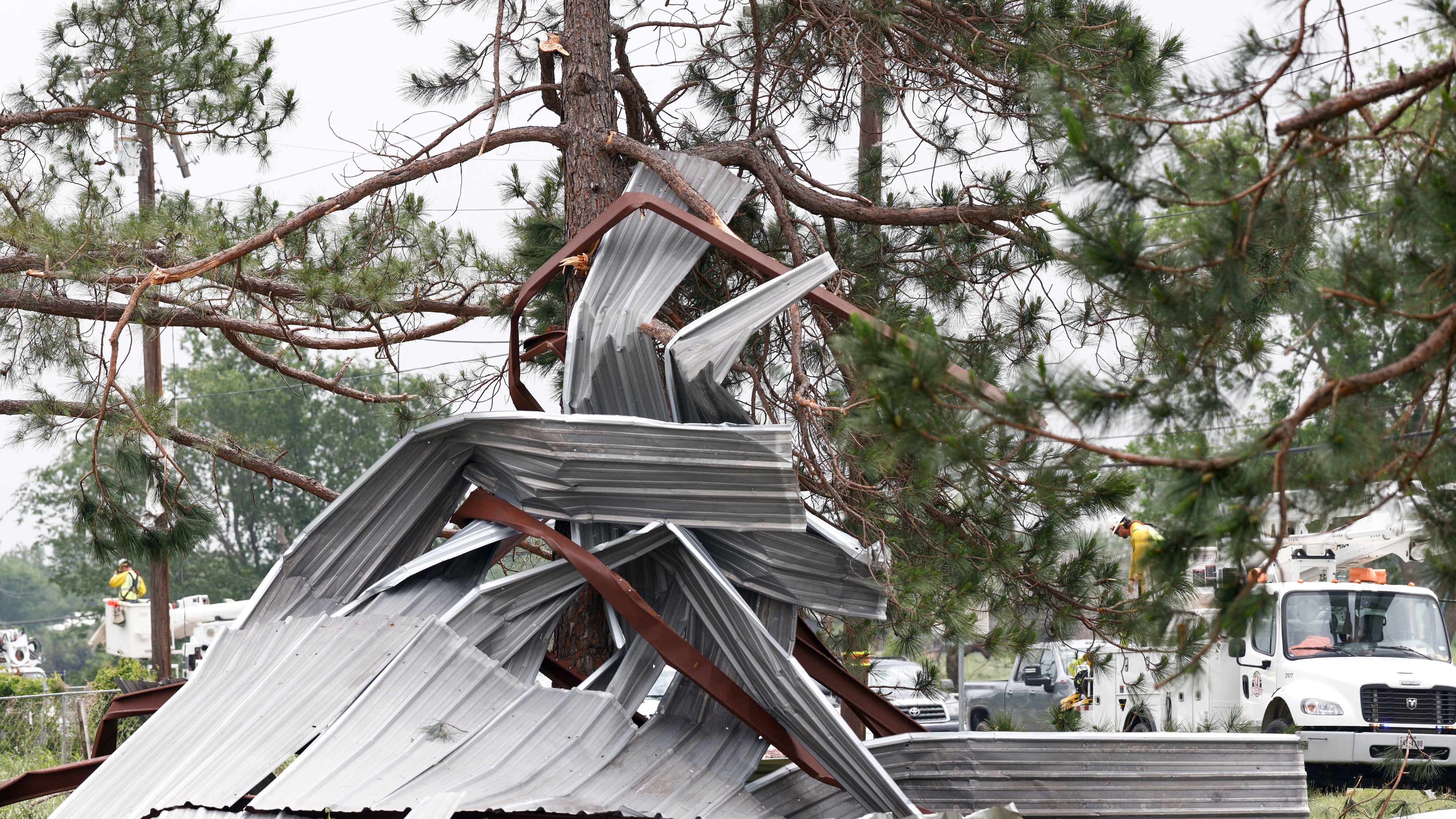 A meal building rests twisted in a tree after a possible tornado, Sunday, April 26, 2026, in Springtown, Texas (Elías Valverde II/The Dallas Morning News via AP)