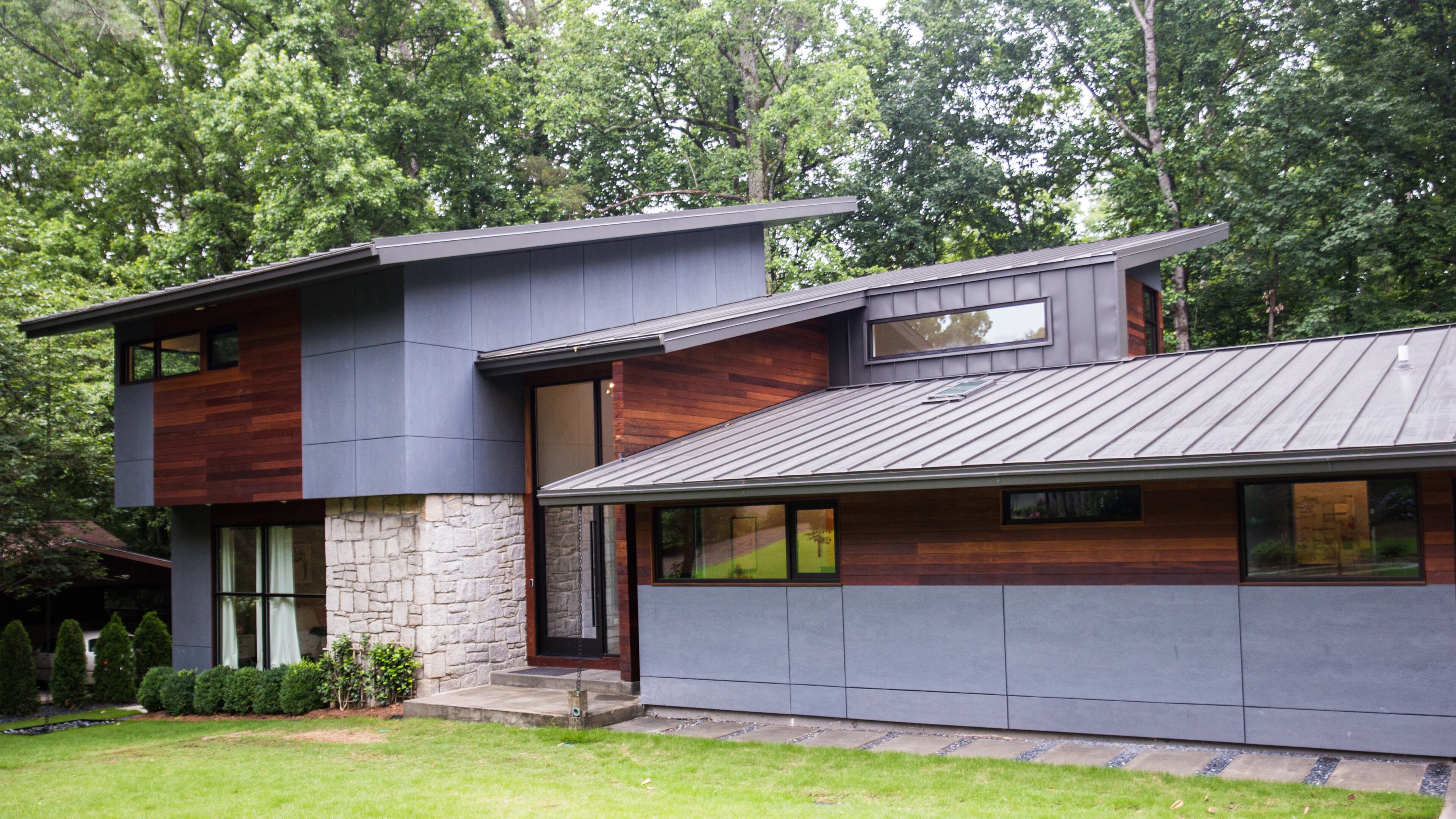 Dan Kaufman and his family live in a classic brick ranch in Chastain Park that has been modernized into a contemporary space with dozens of windows, open staircases, metal roof, pool and basketball court.