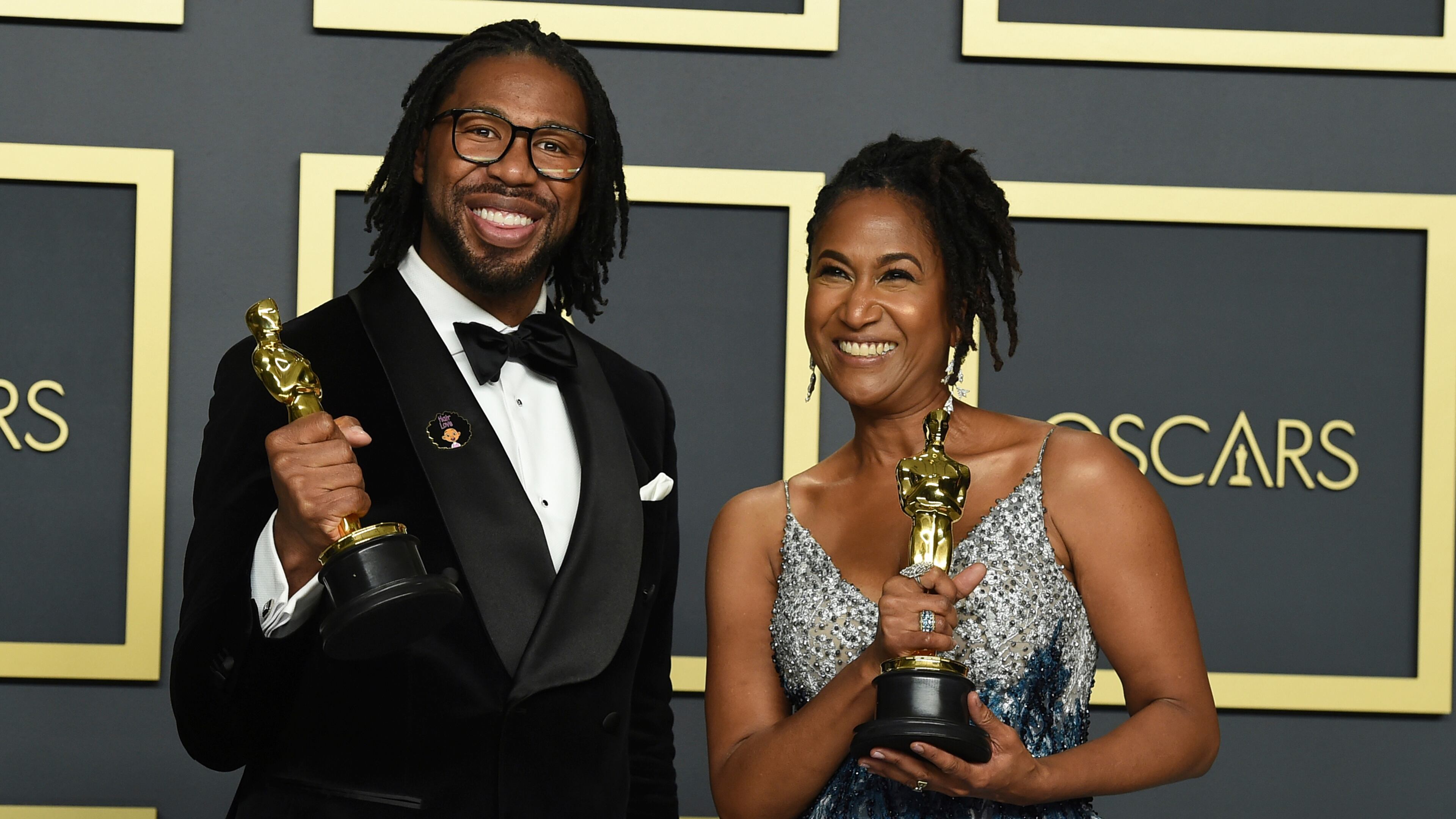 Matthew A. Cherry and Karen Rupert Toliver, winners of the award for Best Animated Short Film for "Hair Love," pose in the press room at the Oscars on Sunday.