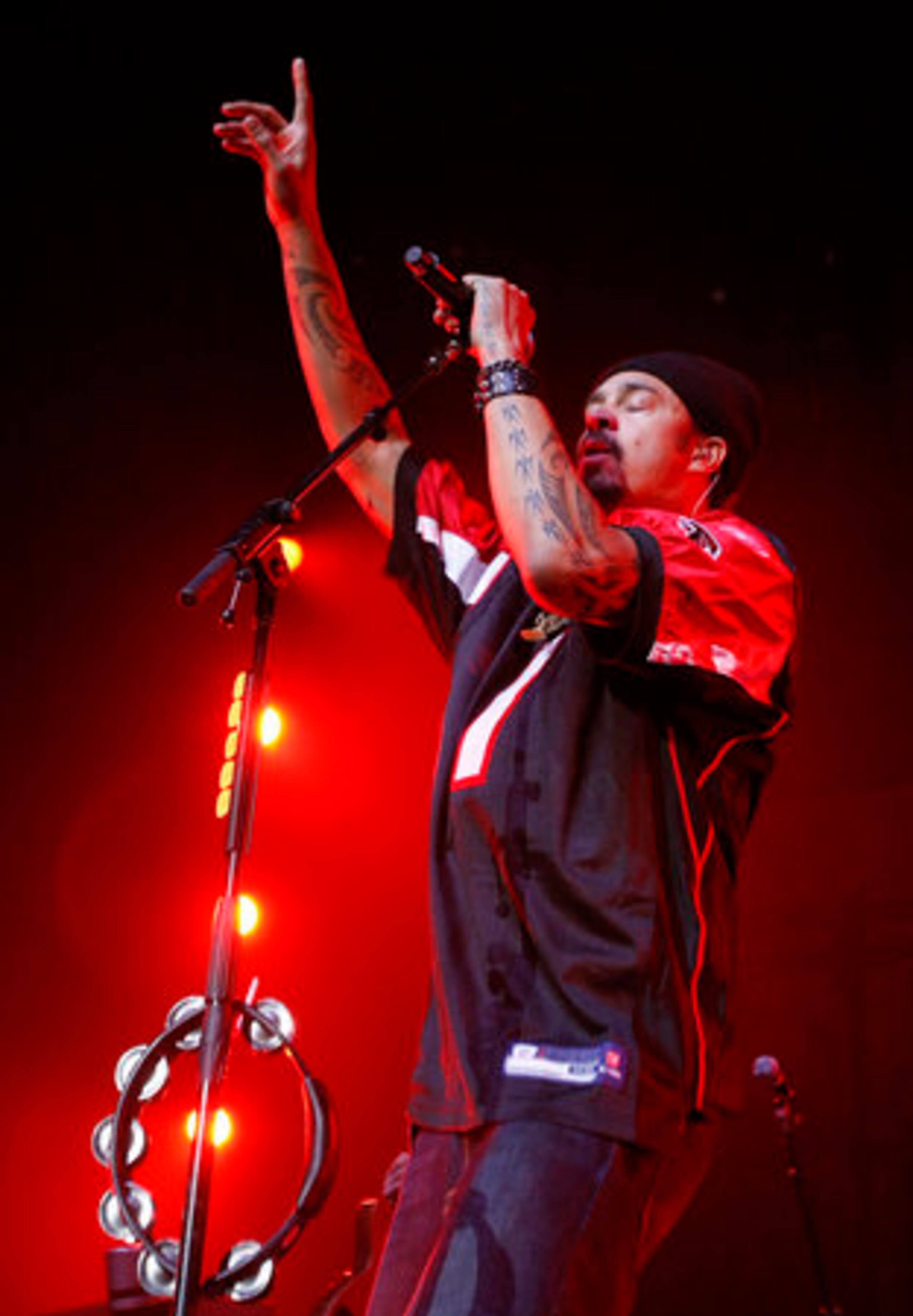 Michael Franti sports a Atlanta Falcons football jersey with the # 1 on it and Franti on the back as he sings a song opening for John Mayer.