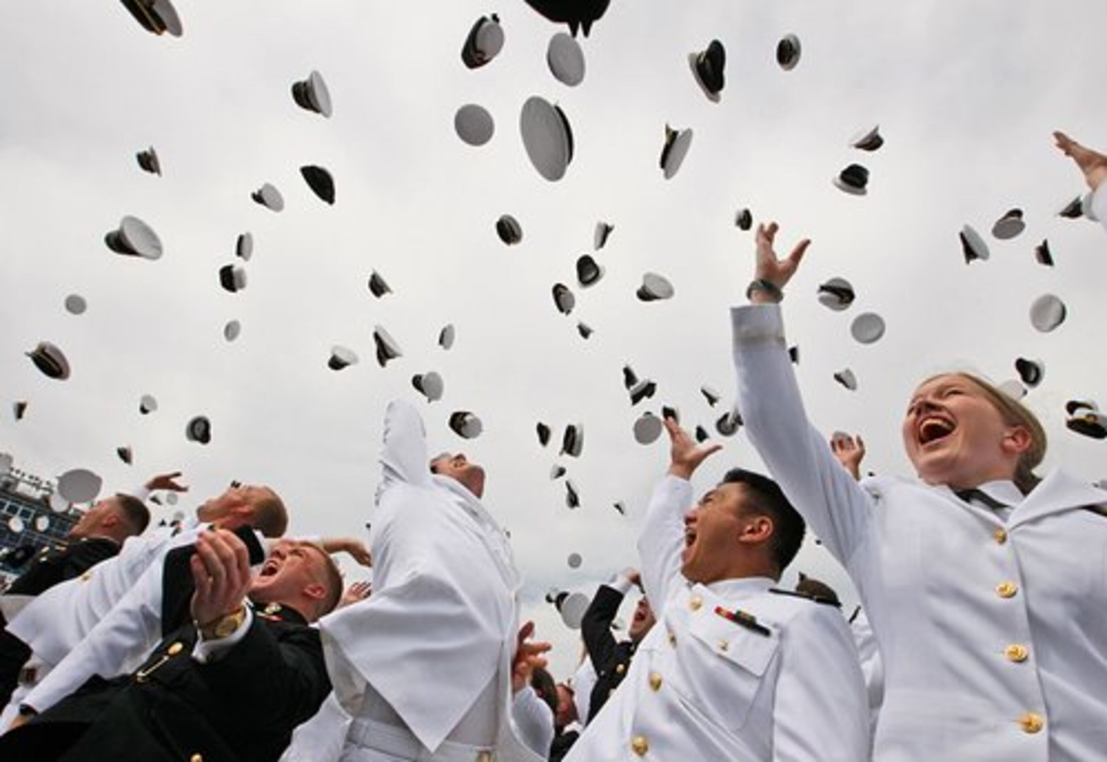 Graduates toss their hats at the end of the United States Naval Academy graduation ceremony.