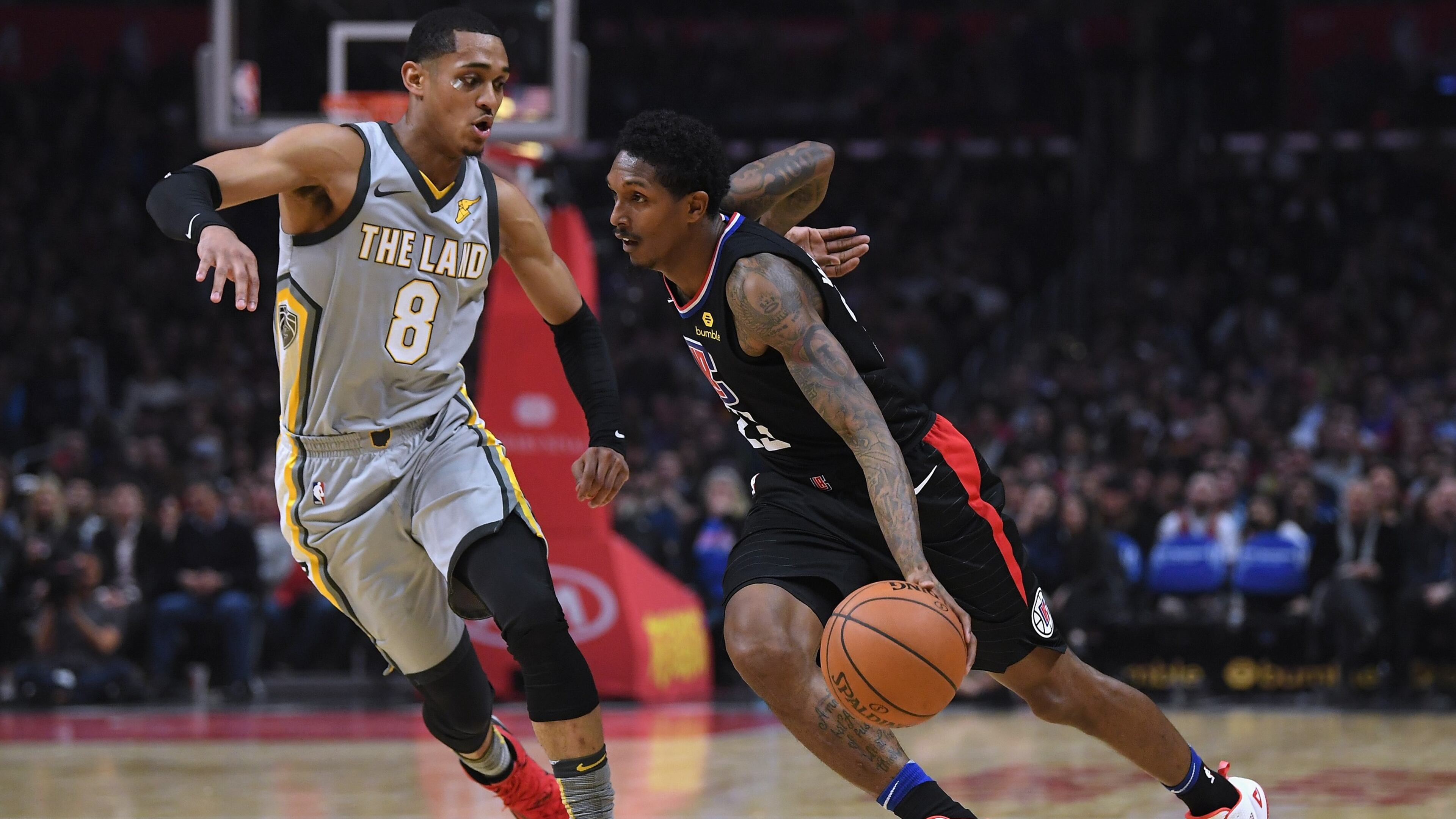 Lou Williams of the LA Clippers drives to the basket on Jordan Clarkson of the Cleveland Cavaliers during the first half against the LA Clippers at Staples Center on March 9, 2018 in Los Angeles, California.