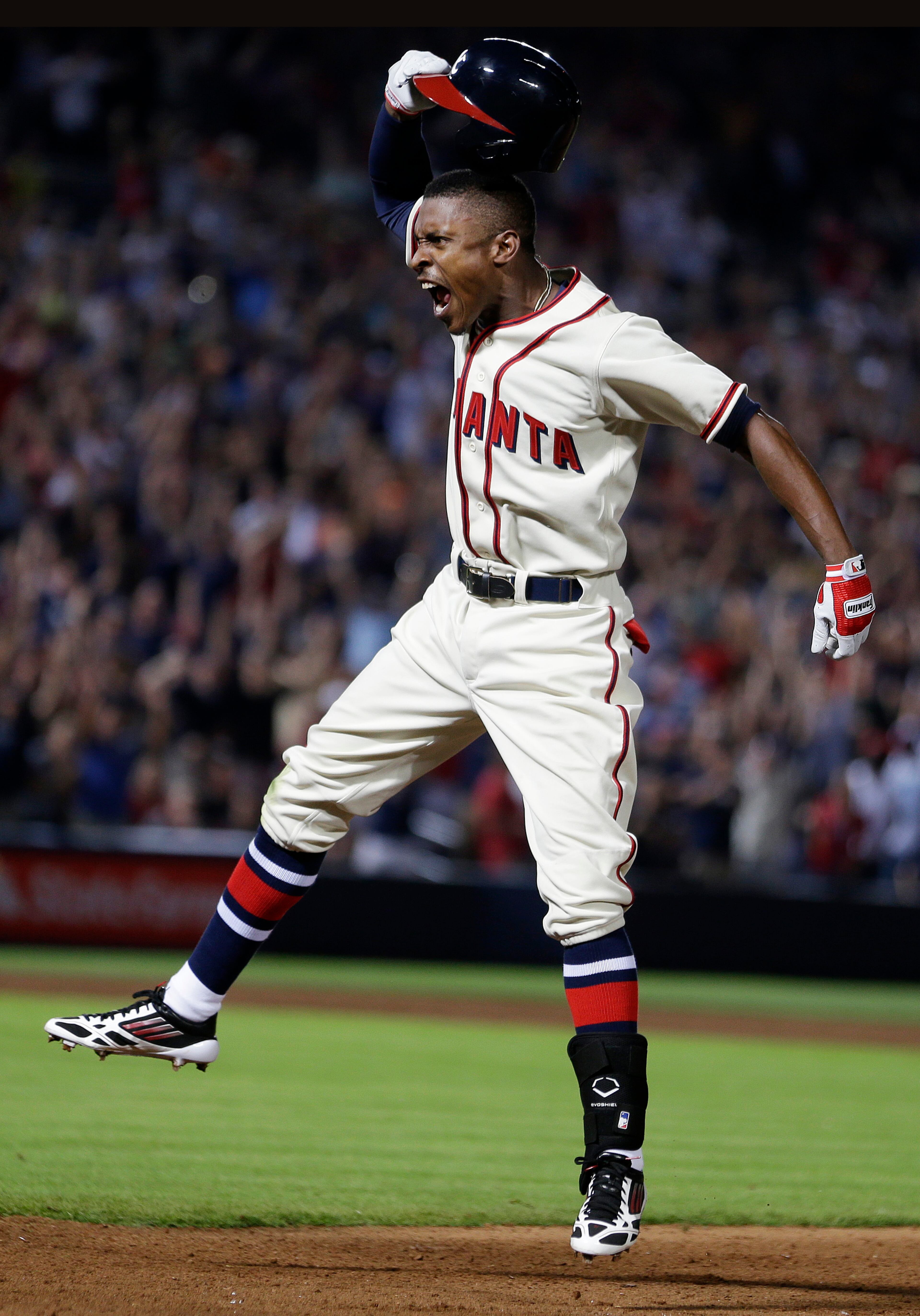 Atlanta Braves' B.J. Upton (2) celebrates after driving in the game-winning run with a base hit in the 10th inning of a baseball game against the Washington Nationals in Atlanta, Saturday, June 1, 2013. Atlanta won 3-2. (AP Photo/John Bazemore)