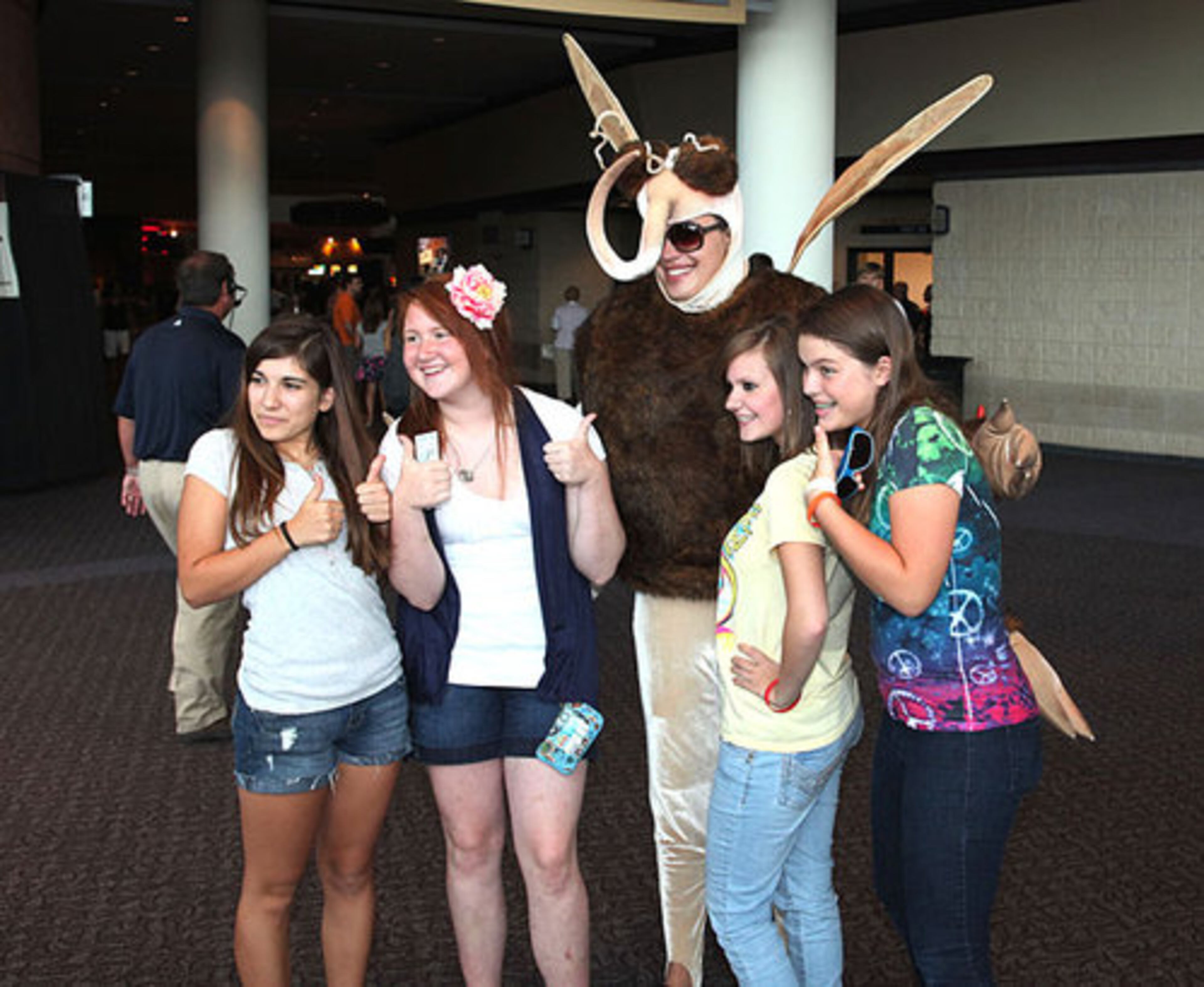 Idols fans pose with Mozzie the Mosquito, who is promoting "Nothing But Nets" as part of the Idols Gives Back charity effort to rid Africa of malaria.