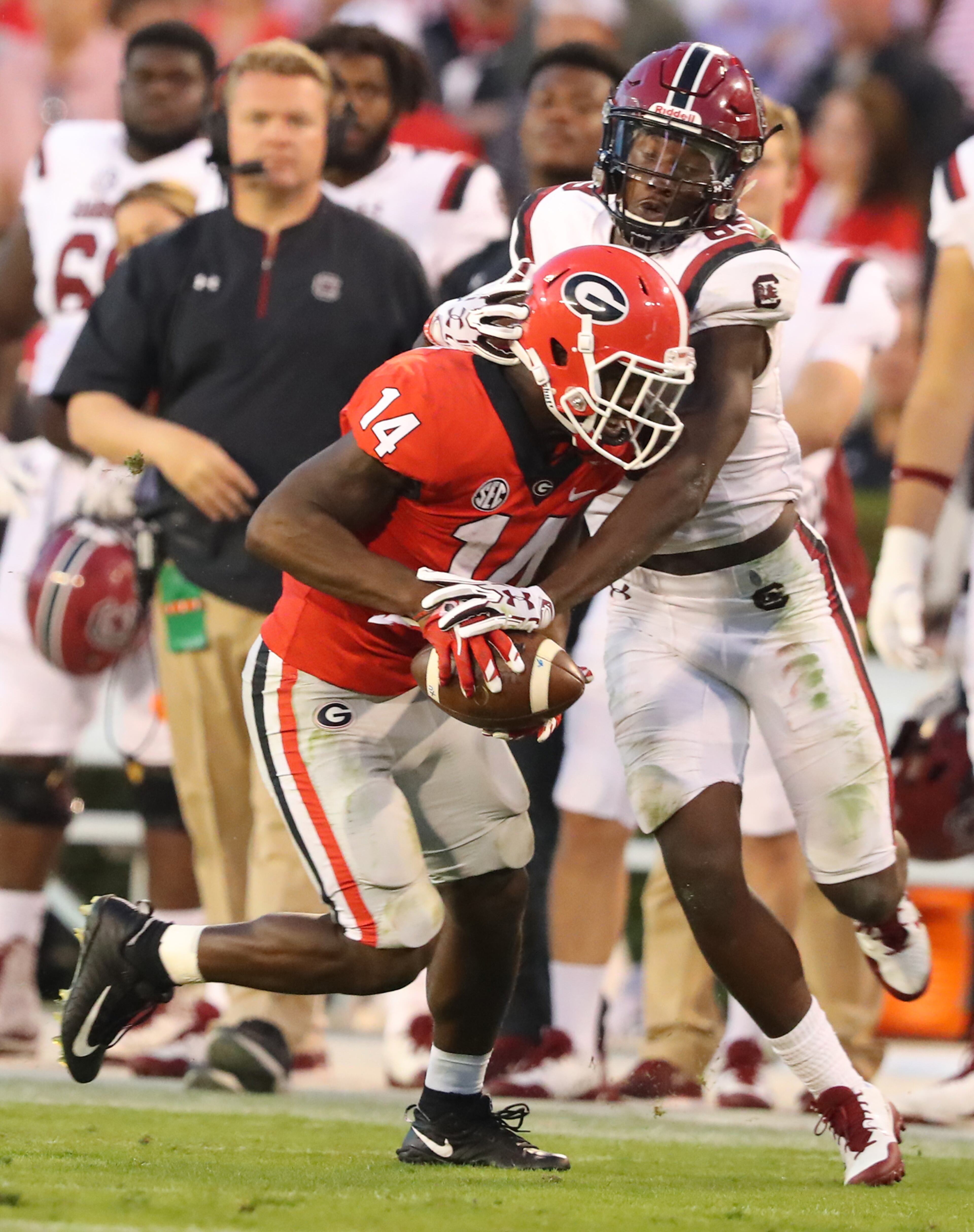 November 4, 2017 Athens: Malkom Parrish intercepts South Carolina quarterback Jake Bentley in front of wide receiver Bryan Edwards in the final minutes of the game for a 24-10 victory and a 9-0 record in a NCAA college football game on Saturday, November 4, 2017, in Athens. Curtis Compton/ccompton@ajc.com