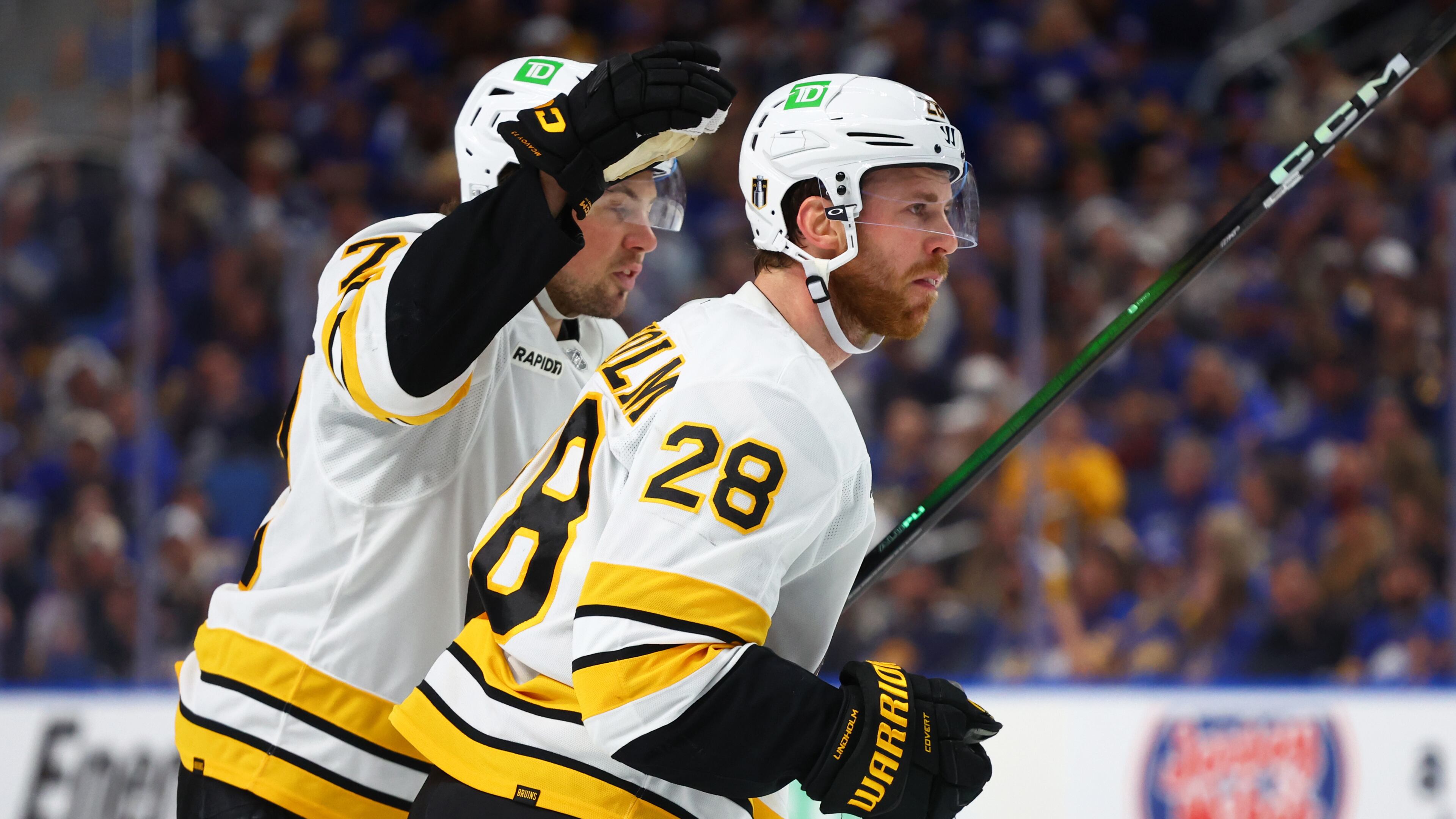 Boston Bruins center Elias Lindholm (28) celebrates his goal with defenseman Charlie McAvoy (73)during the second period in Game 5 of a first-round NHL hockey Stanley Cup playoff series against the Buffalo Sabres Tuesday, April 28, 2026, in Buffalo, N.Y. (AP Photo/Jeffrey T. Barnes)