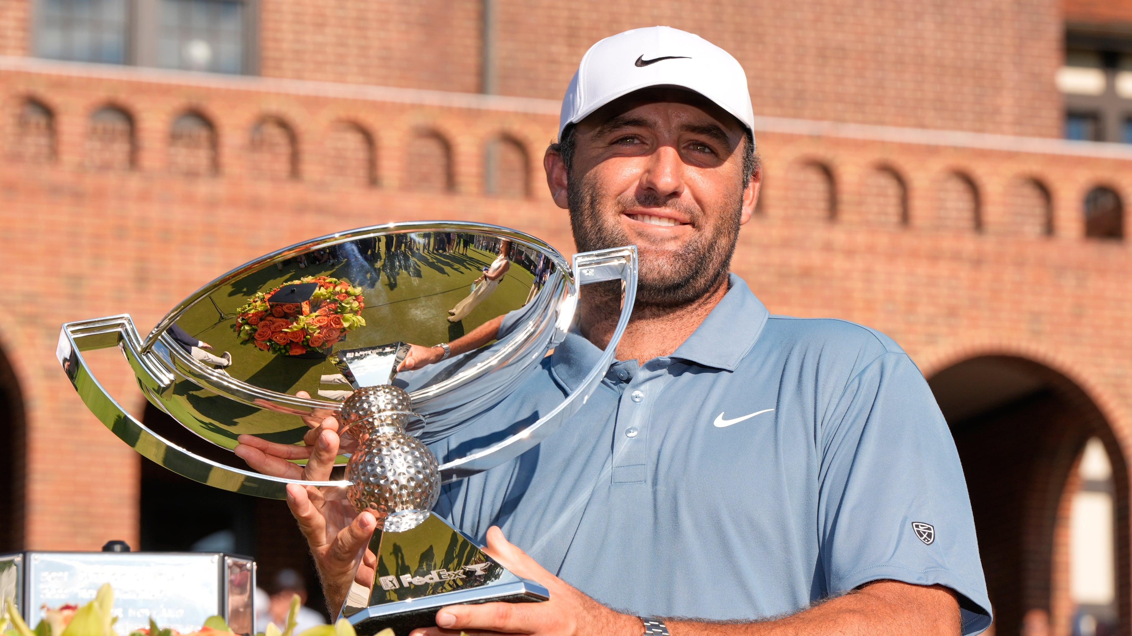 Scottie Scheffler holds the trophy after winning the PGA Tour Championship golf tournament Sunday, Aug. 30, 2026, in Atlanta. (AP Photo/Mike Stewart)