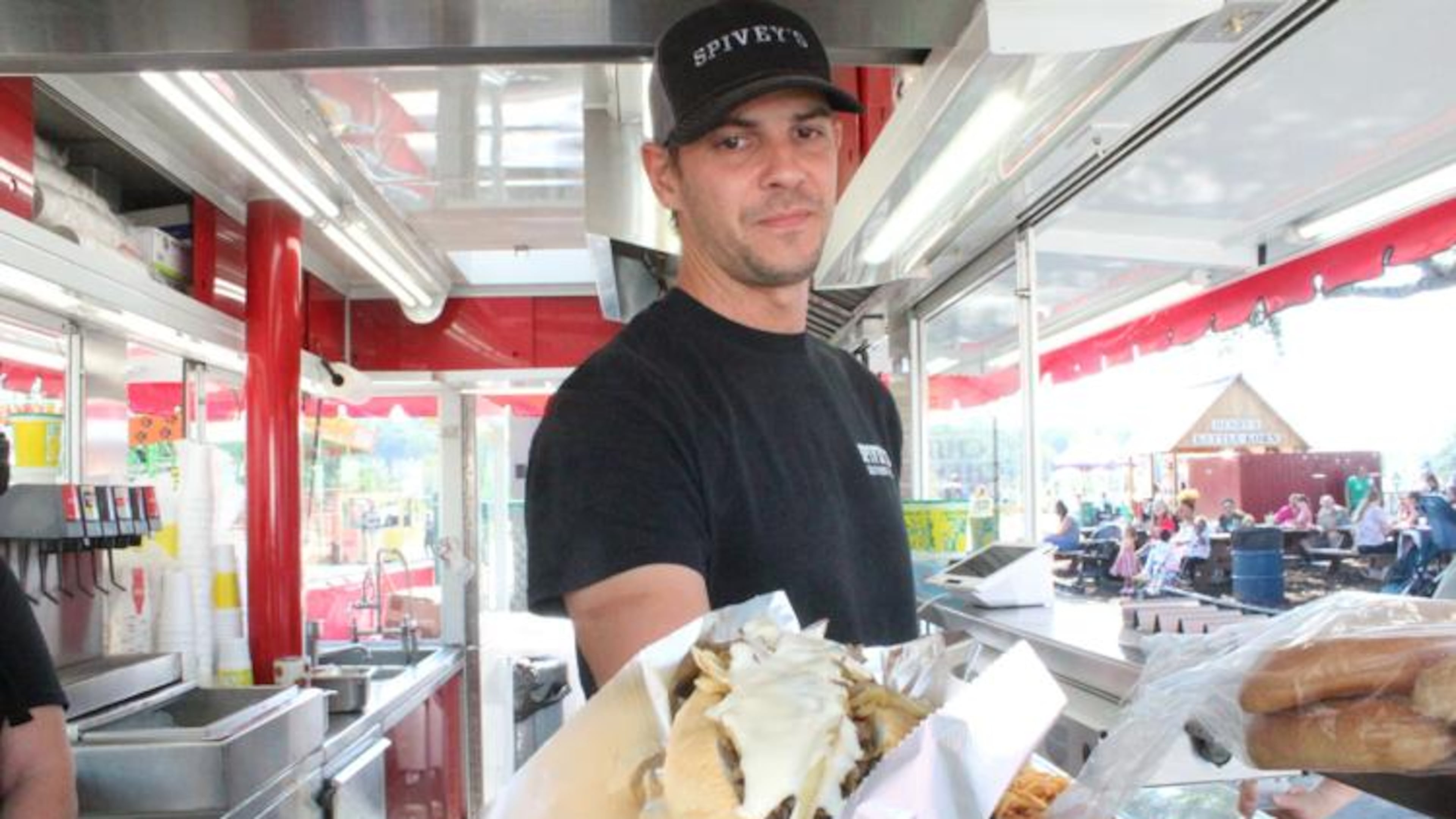An employee for Florida-based Spivey’s Southern Grill, which specializes in cheesesteak sandwiches, shows off one of his creations during the North Georgia State Fair, presented by Superior Plumbing. (Photo Courtesy of Joel Elliott)