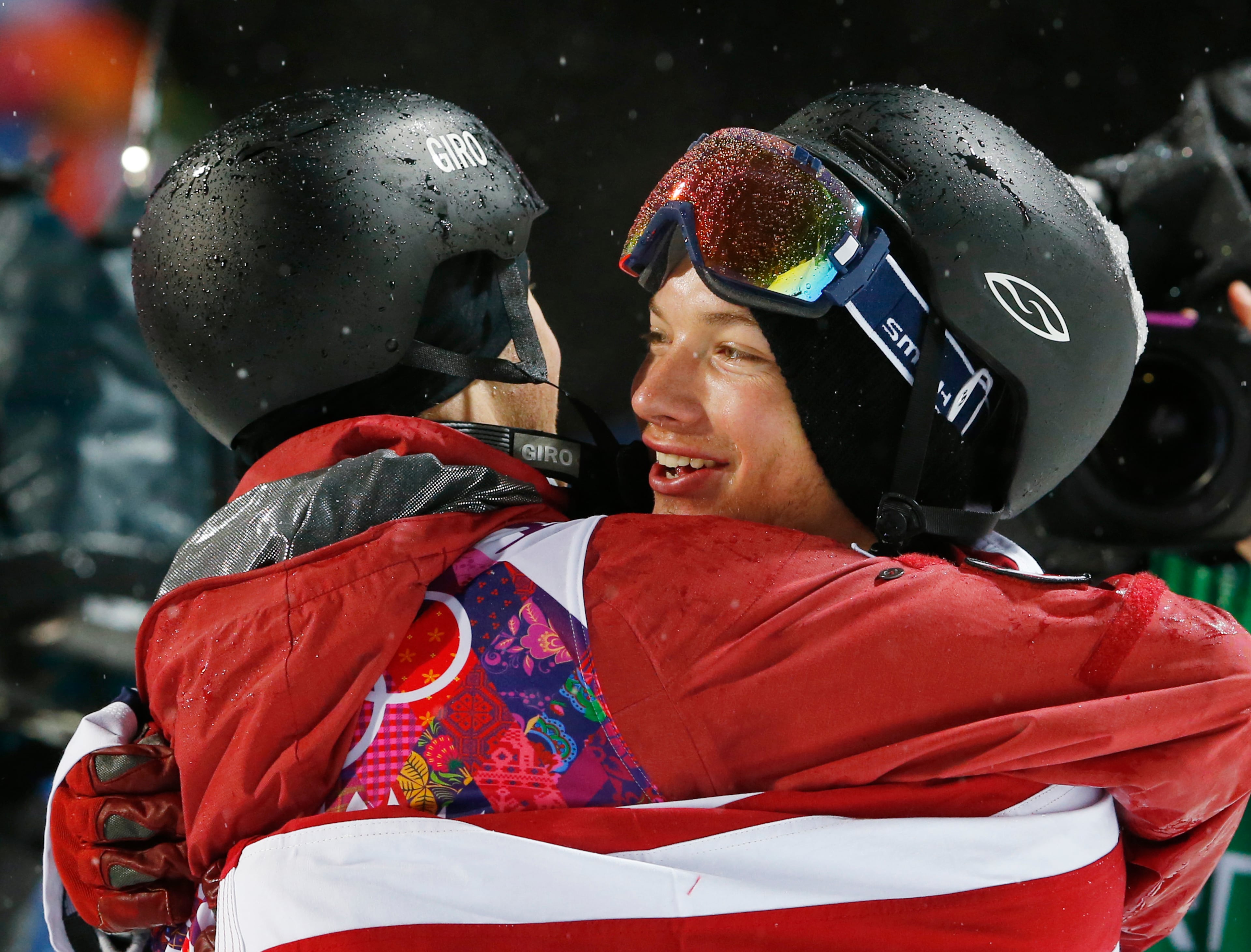 David Wise of the United States, right, is congratulated by Canada's Mike Riddle after Wise won the gold medal in the men's ski halfpipe final at the Rosa Khutor Extreme Park, at the 2014 Winter Olympics, Tuesday, Feb. 18, 2014, in Krasnaya Polyana, Russia. Riddle took the silver medal. (AP Photo/Sergei Grits)