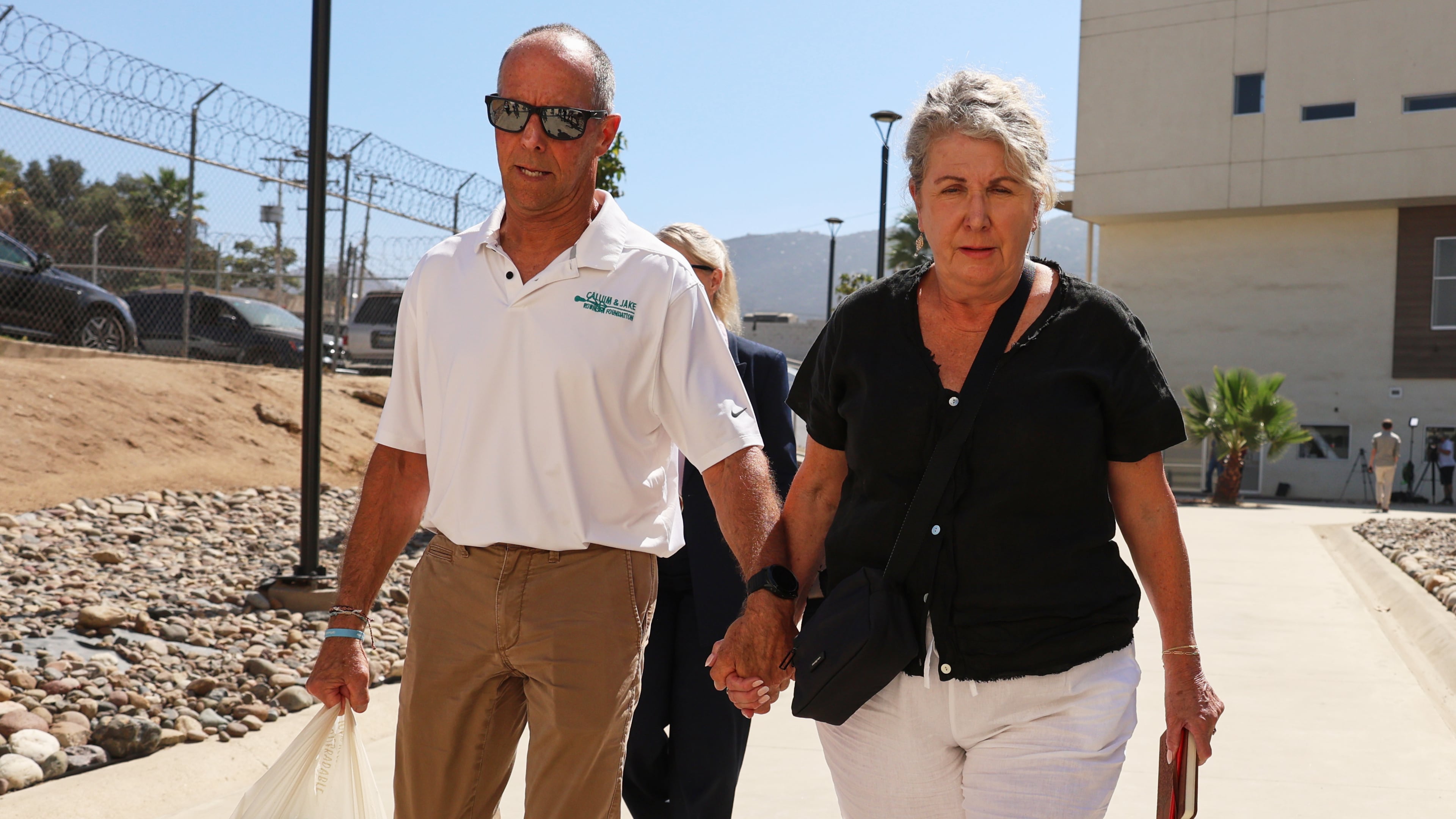 Debra and Martin Robinson, the parents of Australian brothers Callum and Jake Robinson, arrive to court for the trial of the men accused of murdering them, in Ensenada, Mexico, Thursday, Oct. 8, 2026. (AP Photo/Karen Castaneda)