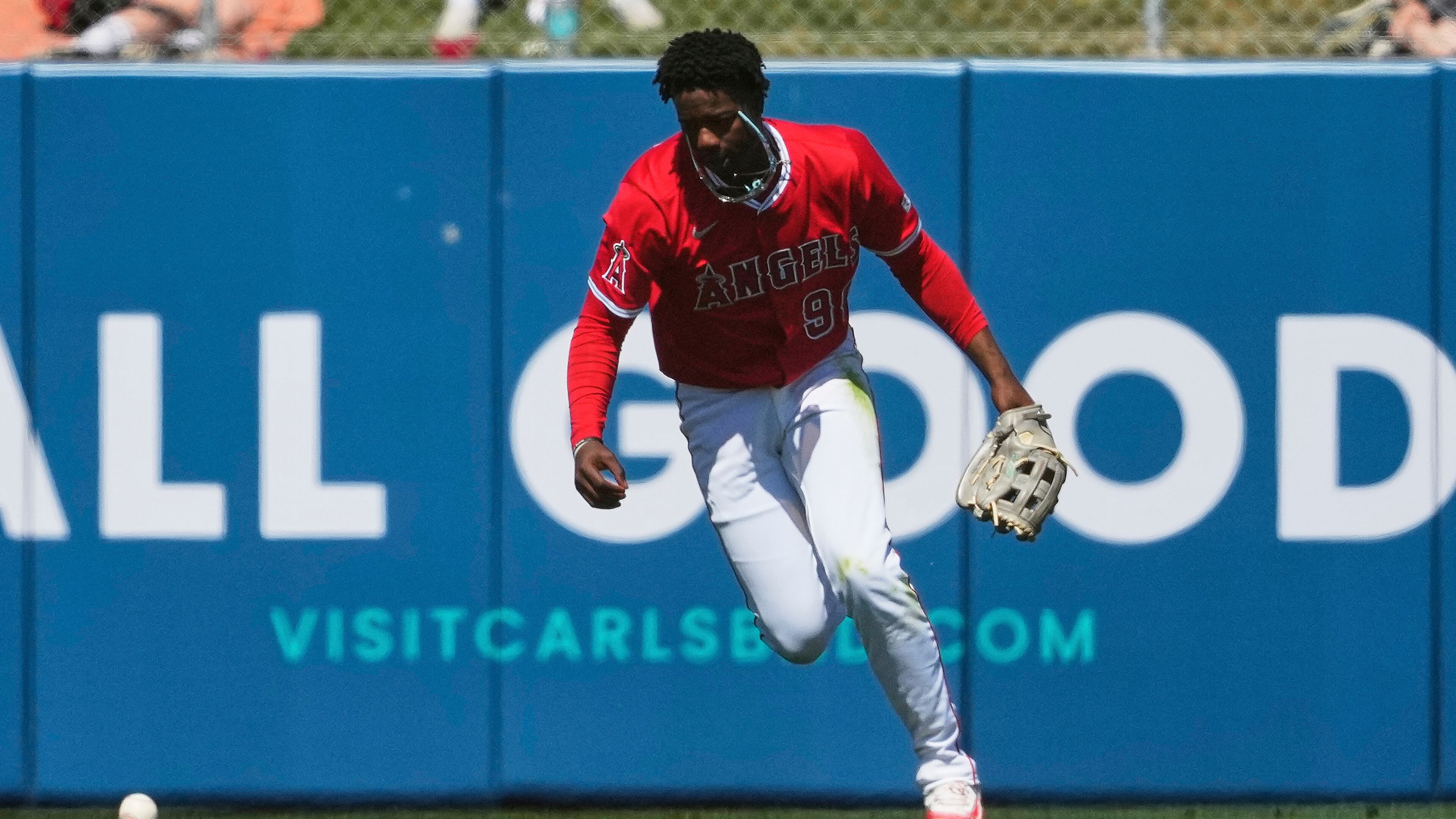 Los Angeles Angels' Rio Foster chases down a base hit Texas Rangers' Jake Burger during the fourth inning of a spring training baseball game, Friday, March 21, 2025, in Tempe, Ariz. (AP Photo/Matt York)