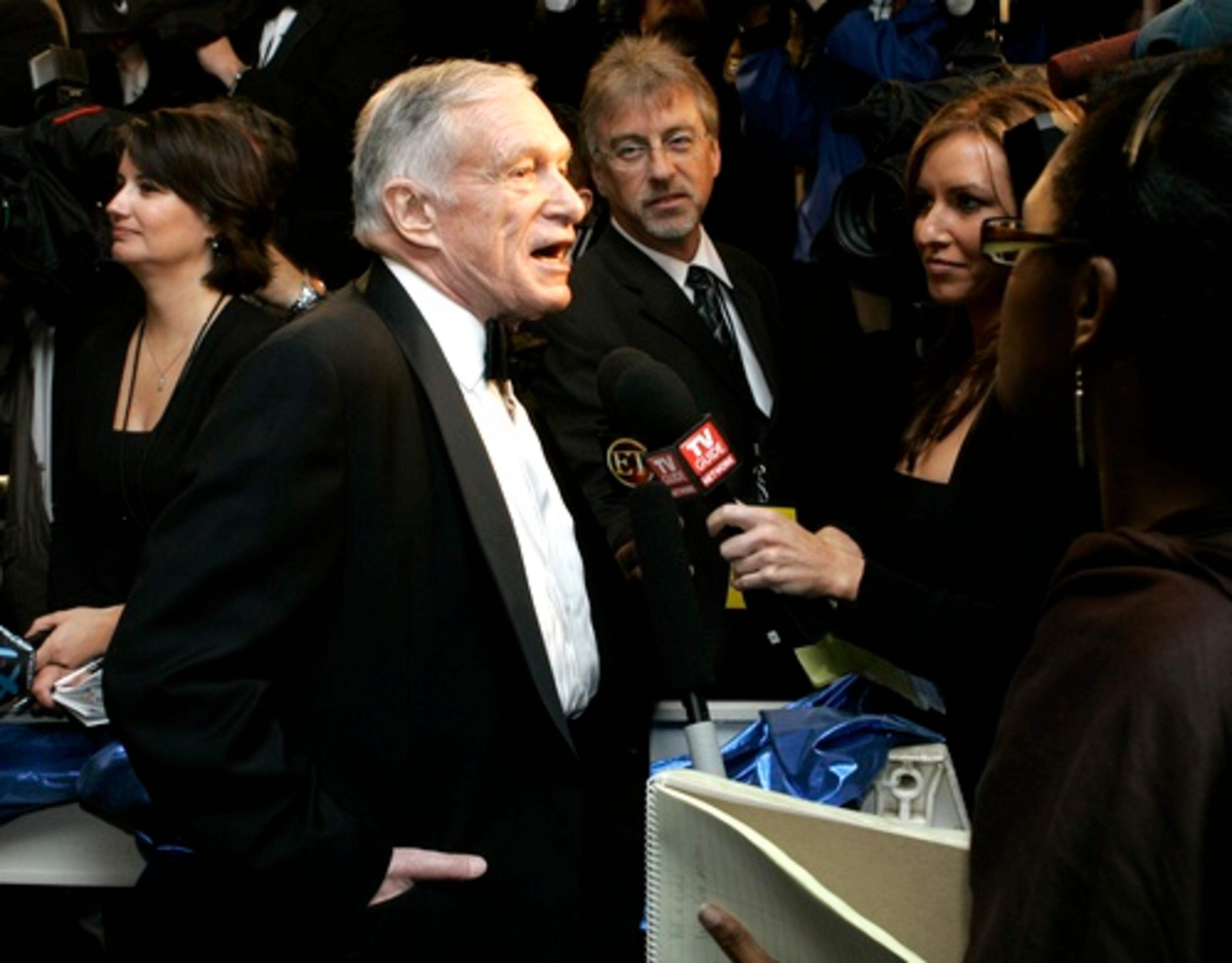 Playboy founder Hugh Hefner speaks to the media after arriving at the party.