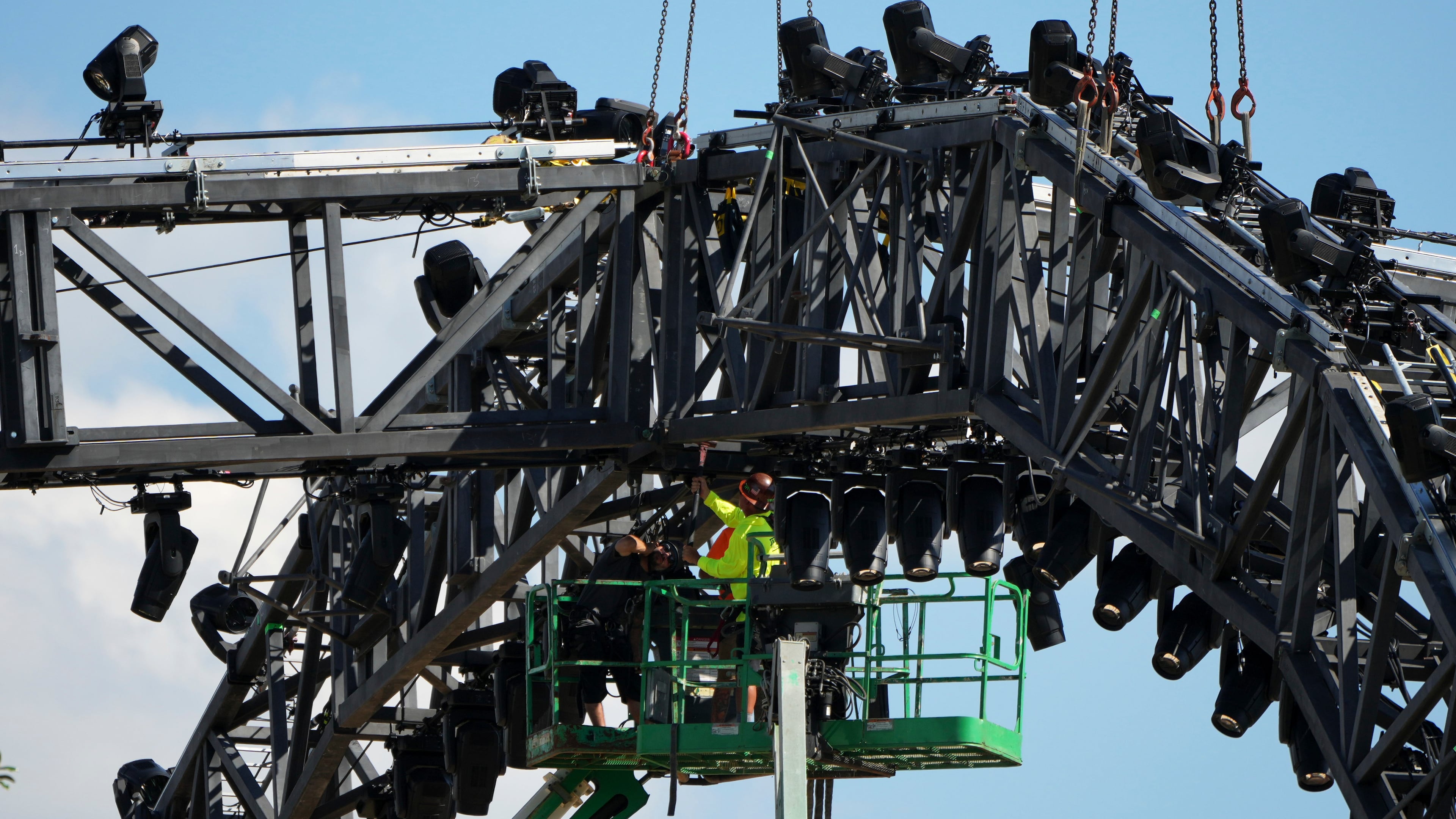 A worker on a lift uses a sledge hammer as crews work to disassemble the structure that was built for UFC Freedom 250 at the White in Washington, Sunday, June 21, 2026. (AP Photo/Mark Schiefelbein)