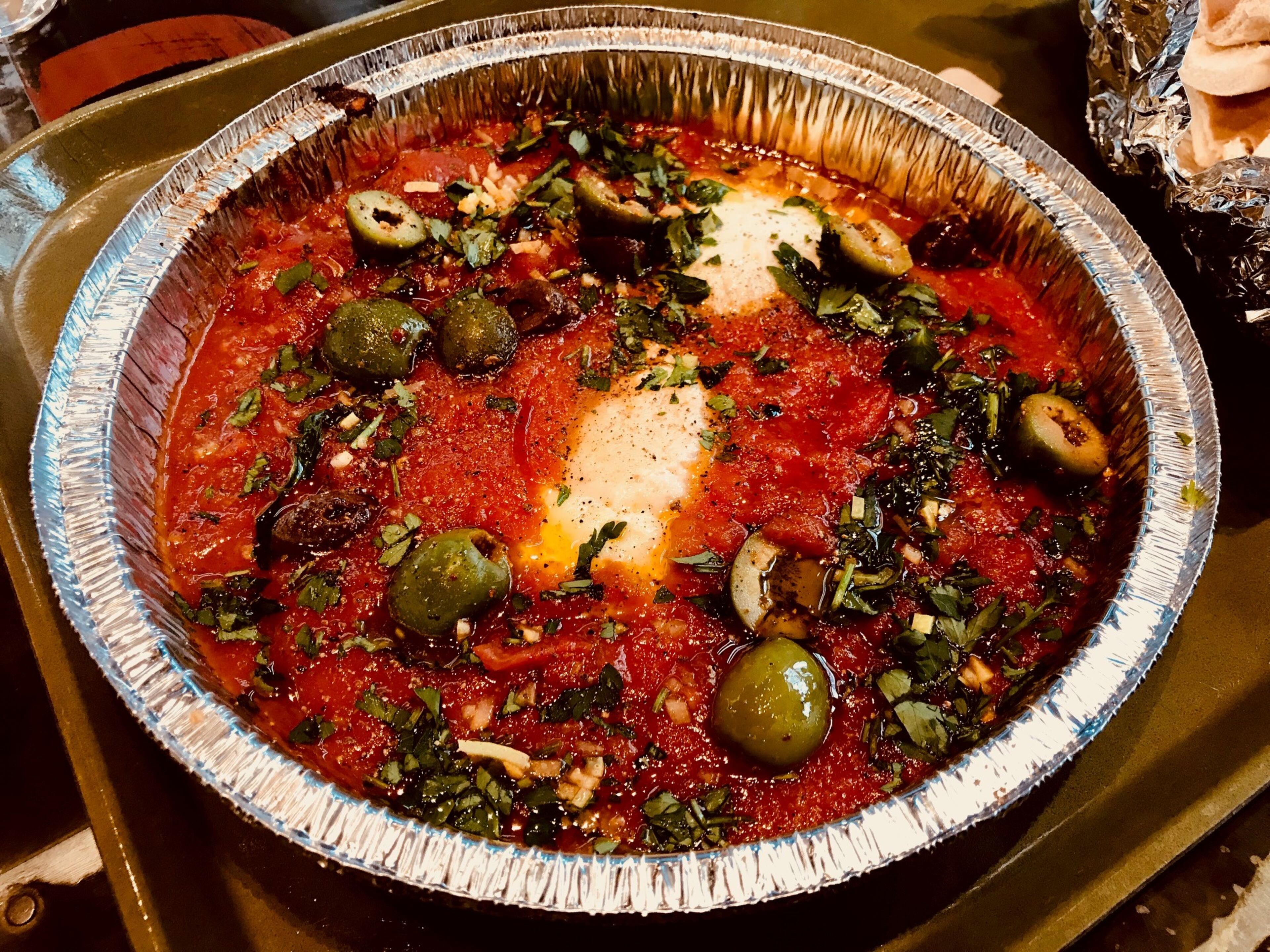 At new Midtown food hall The Canteen, Sunday brunch brings a choice of either shakshuka or a shakshuka shake-up called Hum-Shuka. For the latter (pictured), chef-partner Todd Ginsberg and team bring an added dimension to the dish by layering a ladleful of hummus to the bowl before adding the all-important tomato sauce, which holds Calabrian red pepper and preserved lemon. Photo by Ligaya Figueras