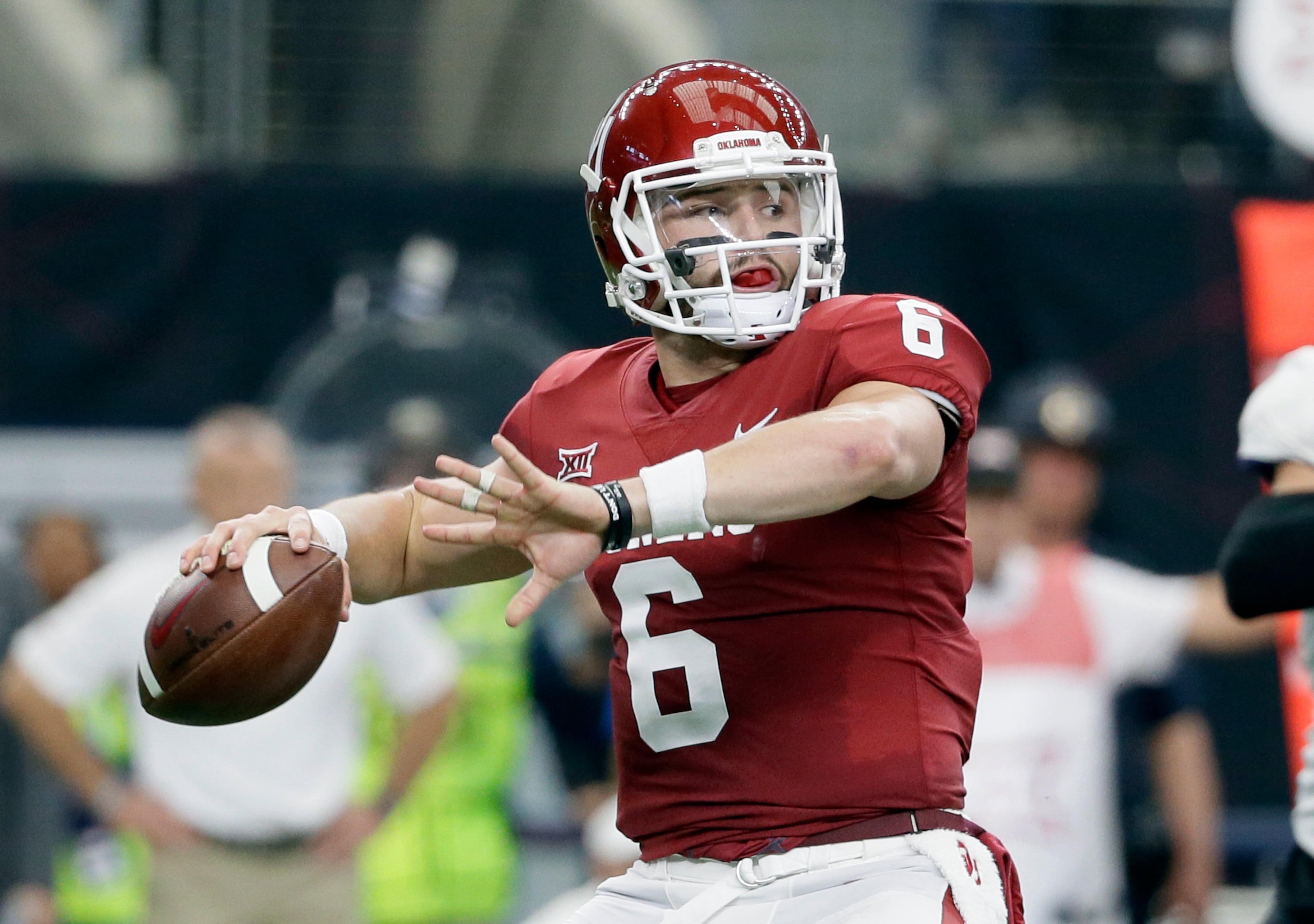 FILE - In this Dec. 2, 2017, file photo, Oklahoma quarterback Baker Mayfield (6) throws a pass in the first half of the Big 12 Conference championship NCAA college football game against TCU in Arlington, Texas. Mayfield, reigning Heisman winner Lamar Jackson of Louisville and Stanford running back Bryce Love were chosen as finalists for the Heisman Trophy on Monday, Dec. 4, 2017. (AP Photo/Tony Gutierrez, File)