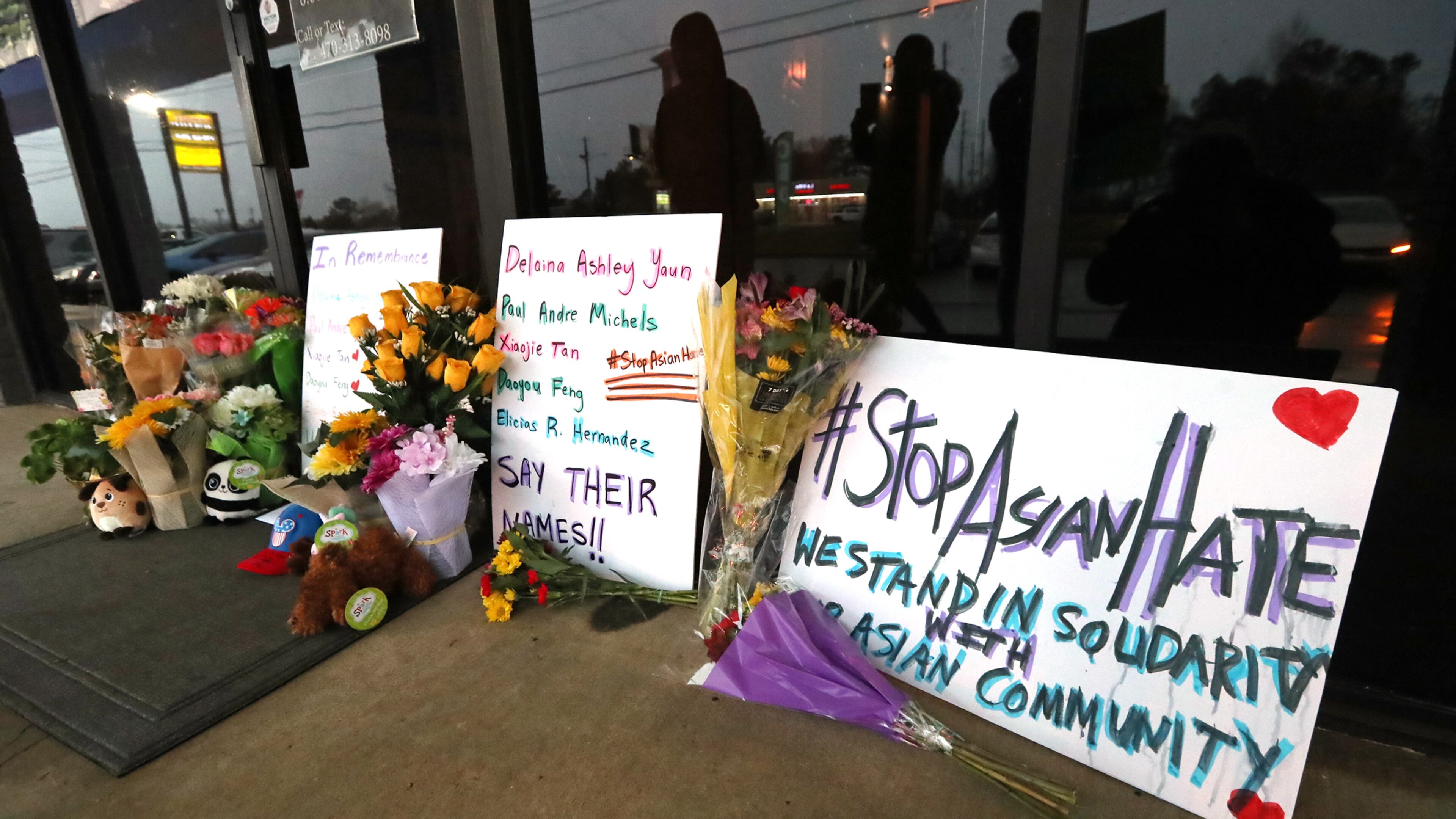 A memorial grows larger by the hour outside Young’s Asian Massage, where four people were killed on Wednesday, March 17, 2021, in Acworth. At least eight people were found dead at three different spas in the Atlanta area March 16. Robert Aaron Long, 21, was charged in the shooting spree, which began at Young’s Asian Massage. (Curtis Compton / Curtis.Compton@ajc.com)
