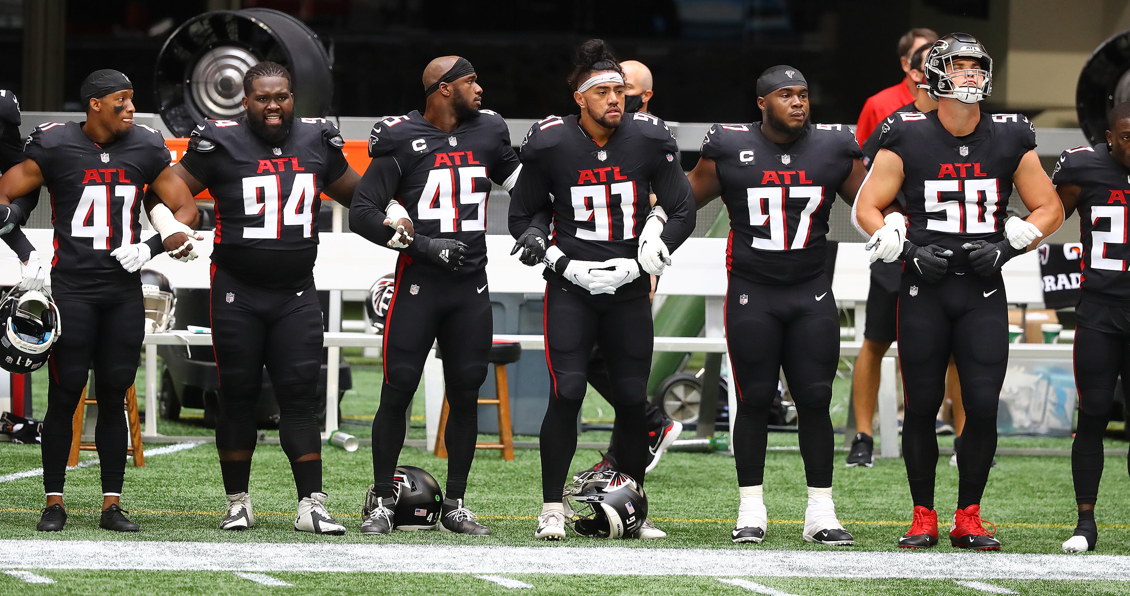 091320 Atlanta: Atlanta Falcons players join arms for the national anthem to begin the season opening game against the Seattle Seahawks Sunday, Sept. 13, 2020, at Mercedes-Benz Stadium in Atlanta. (Curtis Compton / Curtis.Compton@ajc.com)