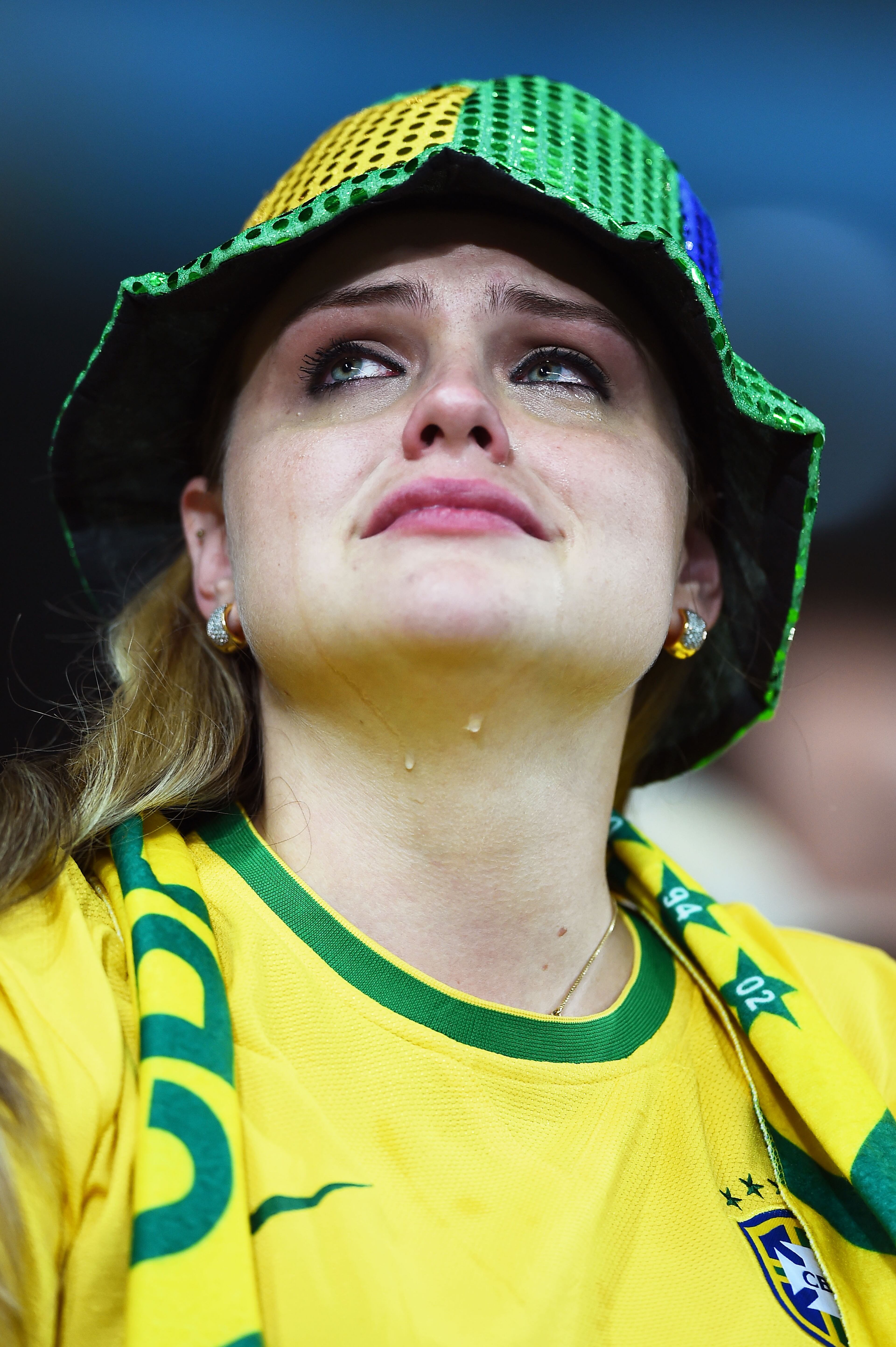 An emotional Brazil fan reacts after being defeated by Germany 7-1 during the 2014 FIFA World Cup Brazil Semifinal match between Brazil and Germany at Estadio Mineirao on July 8, 2014 in Belo Horizonte, Brazil. (Photo by Laurence Griffiths/Getty Images)