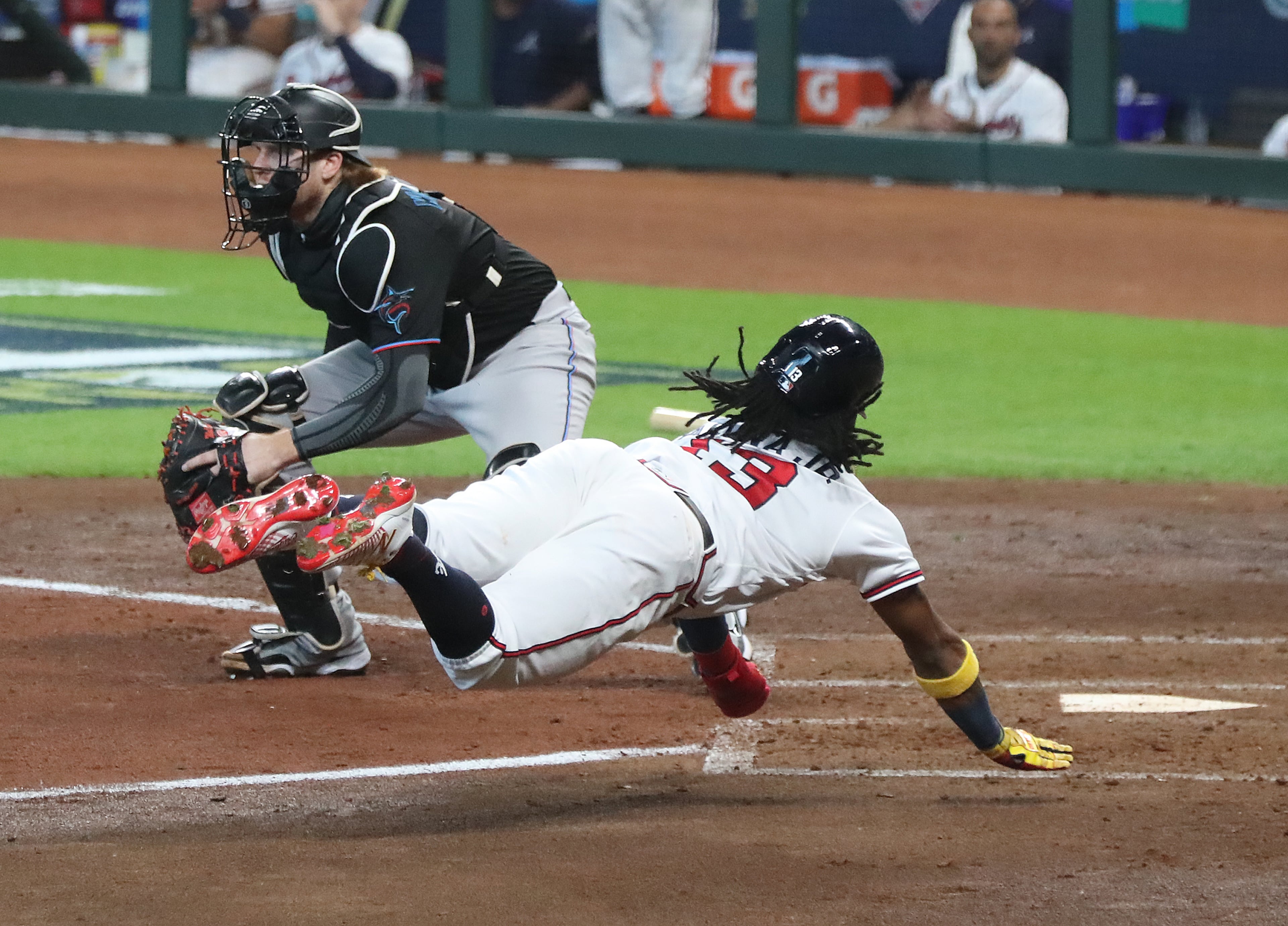 Braves' Ronald Acuna scores from first base past Miami Marlins catcher Chad Wallach during the third inning of Game 1 on a double by Marcell Ocuna in a National League Division Series at Minute Maid Park on Tuesday, Oct 6, 2020 in Houston. “Curtis Compton / Curtis.Compton@ajc.com”