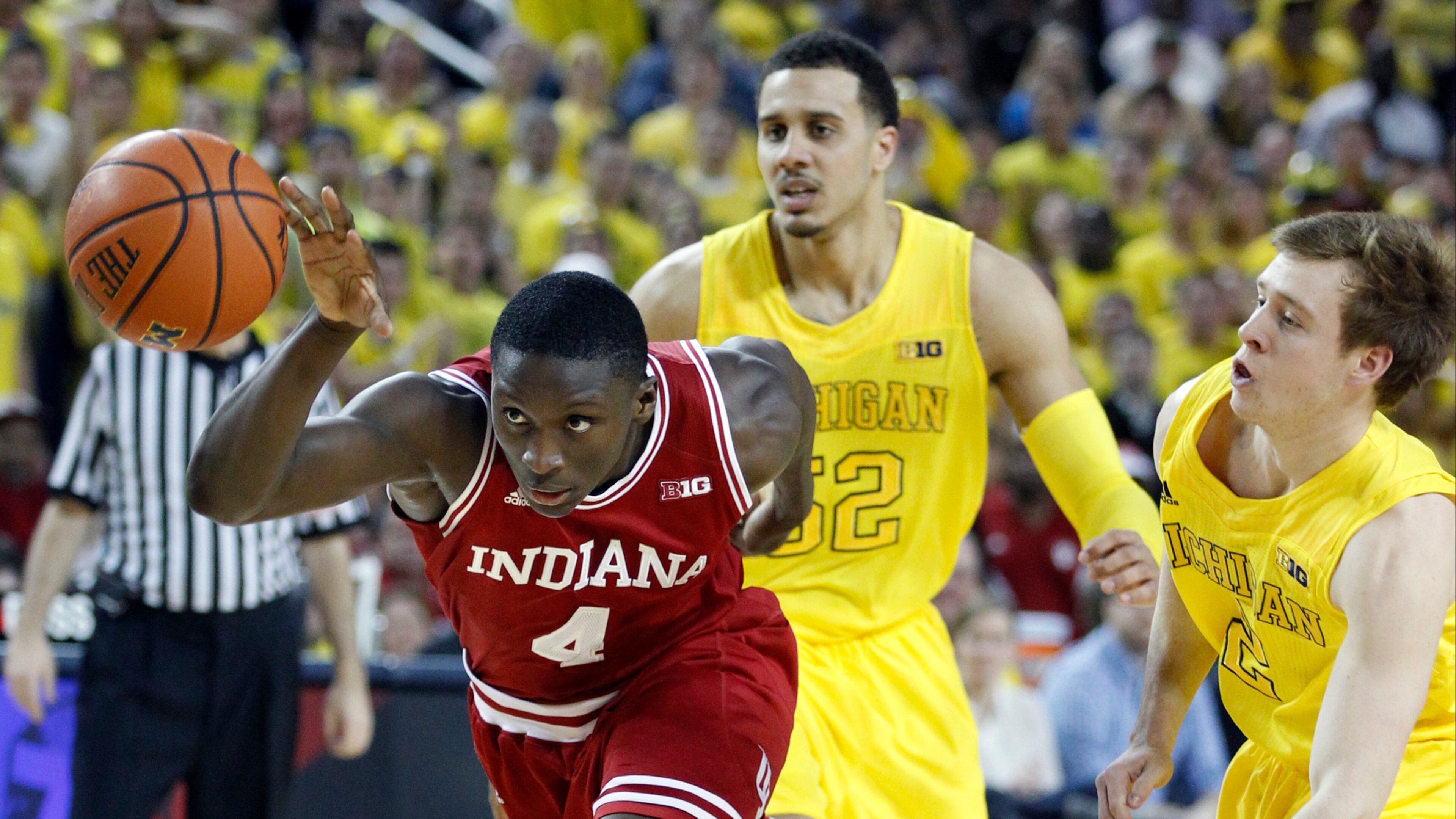 Indiana guard Victor Oladipo (4) drives to the basket while pursued by Michigan forward Jordan Morgan (52) and guard Spike Albrecht (2) during the first half of an NCAA college basketball game Sunday, March 10, 2013, in Ann Arbor, Mich. (AP Photo/Duane Burleson)