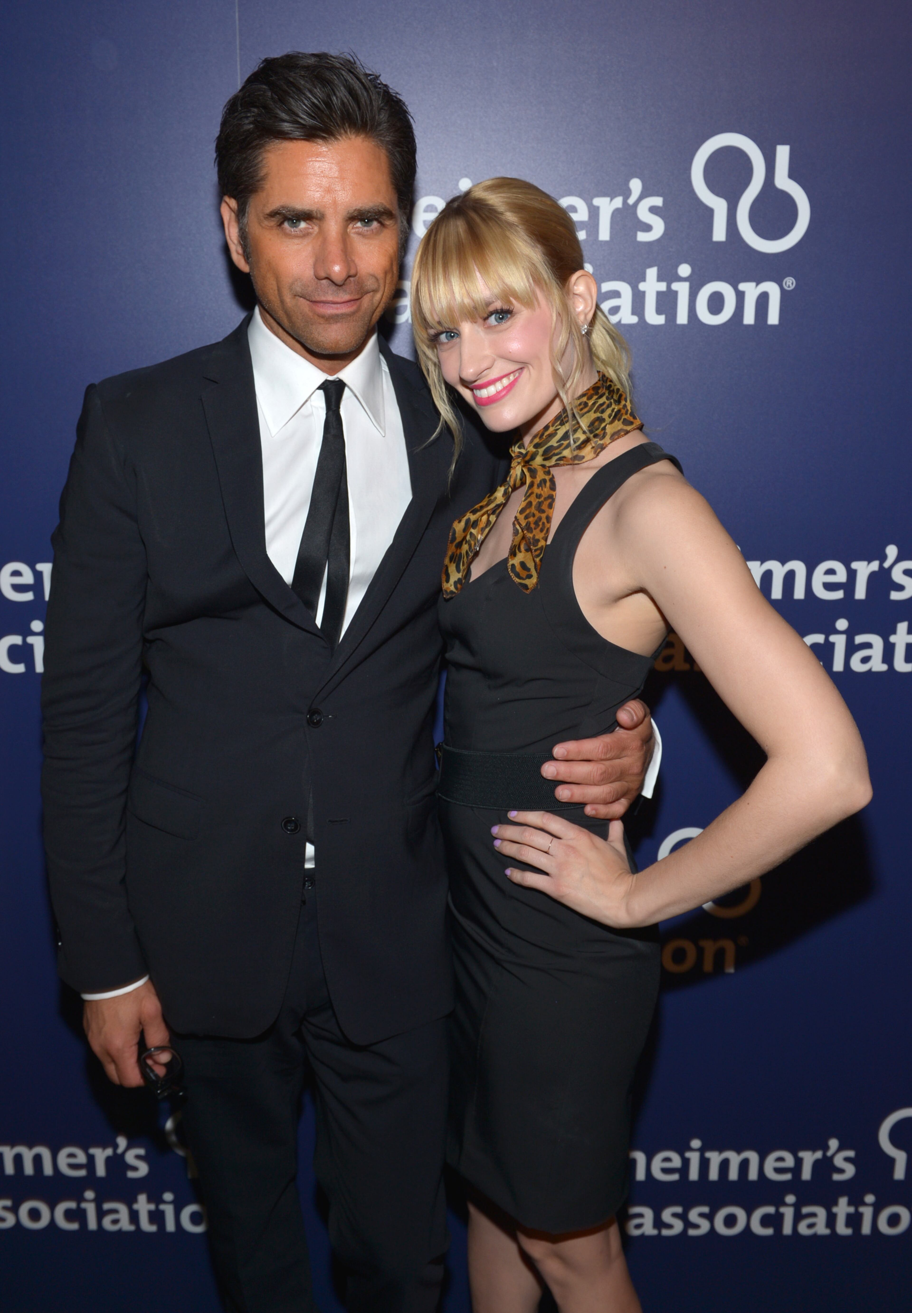 John Stamos, left, and Beth Behrs pose backstage at the 22nd annual "A Night At Sardi's" to benefit the Alzheimer's Association at the Beverly Hilton Hotel on Wednesday, March 26, 2014, in Beverly Hills, Calif.