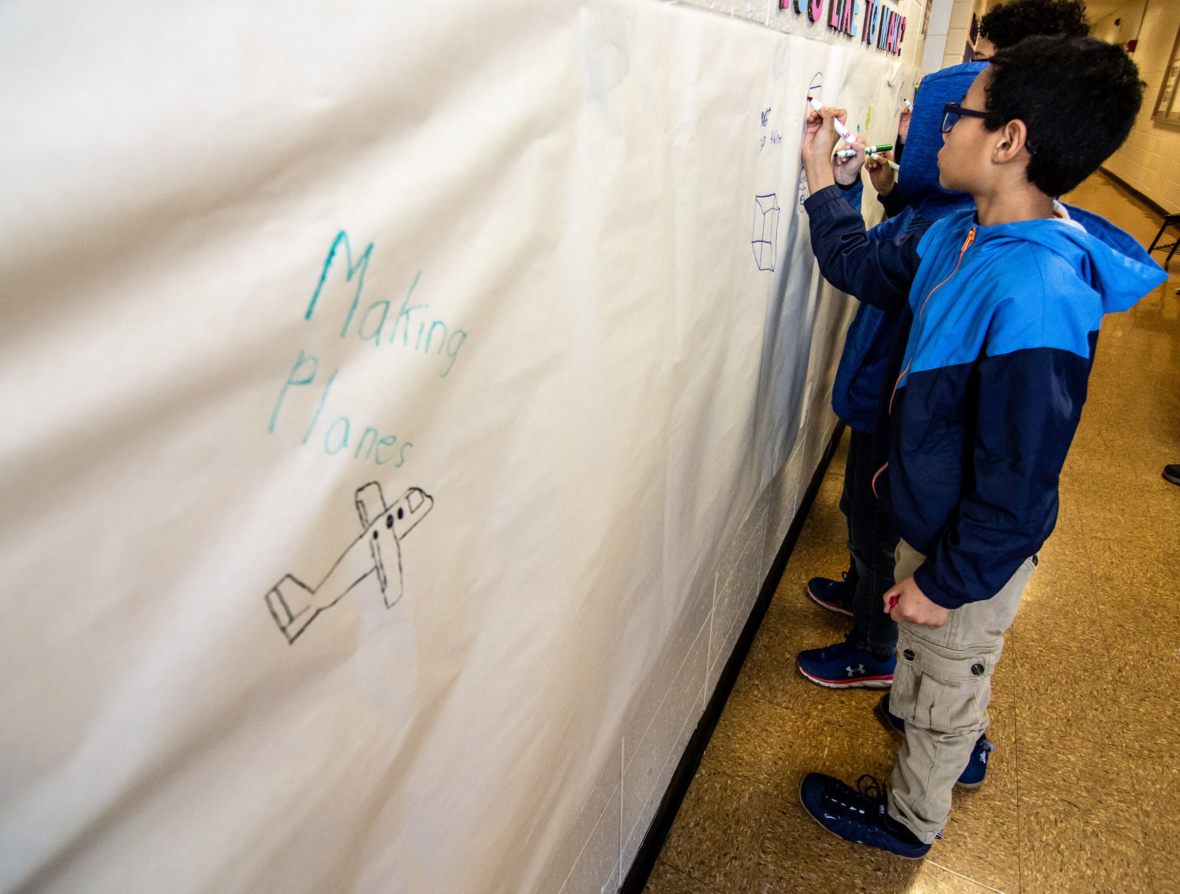 Ethan Sims draws when he wants to make on the wall before entering the Genius Camp in the ExLab at Georgia State University on Saturday, March 7, 2020. STEVE SCHAEFER / SPECIAL TO THE AJC