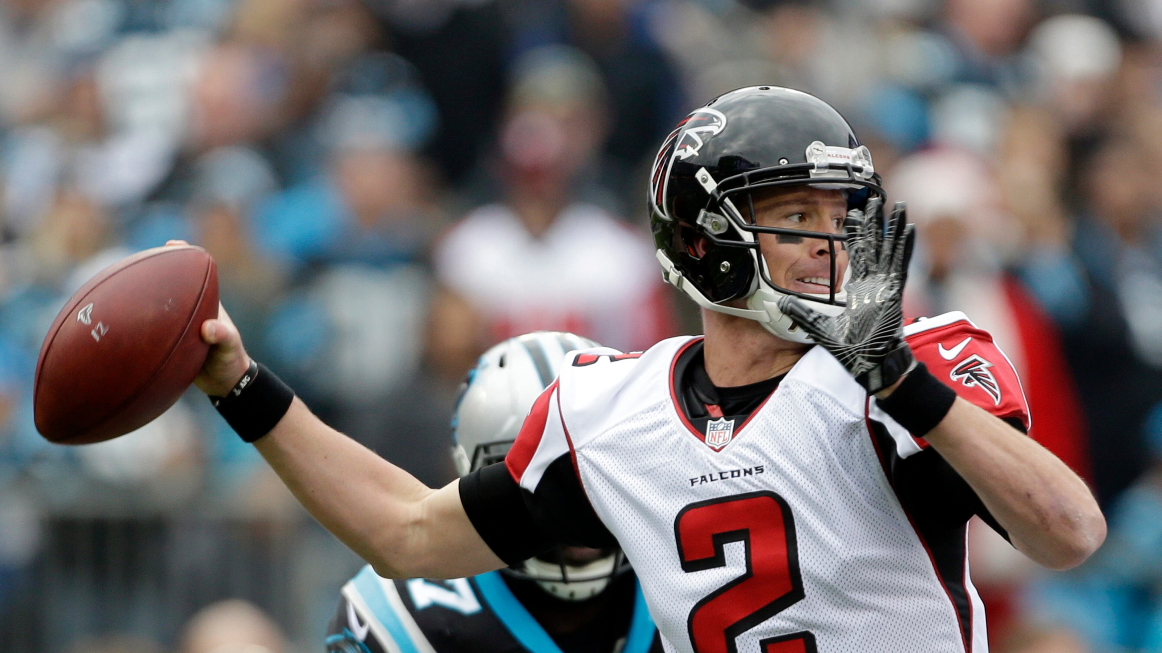 In this Dec. 24, 2016 photo, Atlanta Falcons' Matt Ryan (2) looks to pass against the Carolina Panthers in the first half of an NFL football game in Charlotte, N.C.