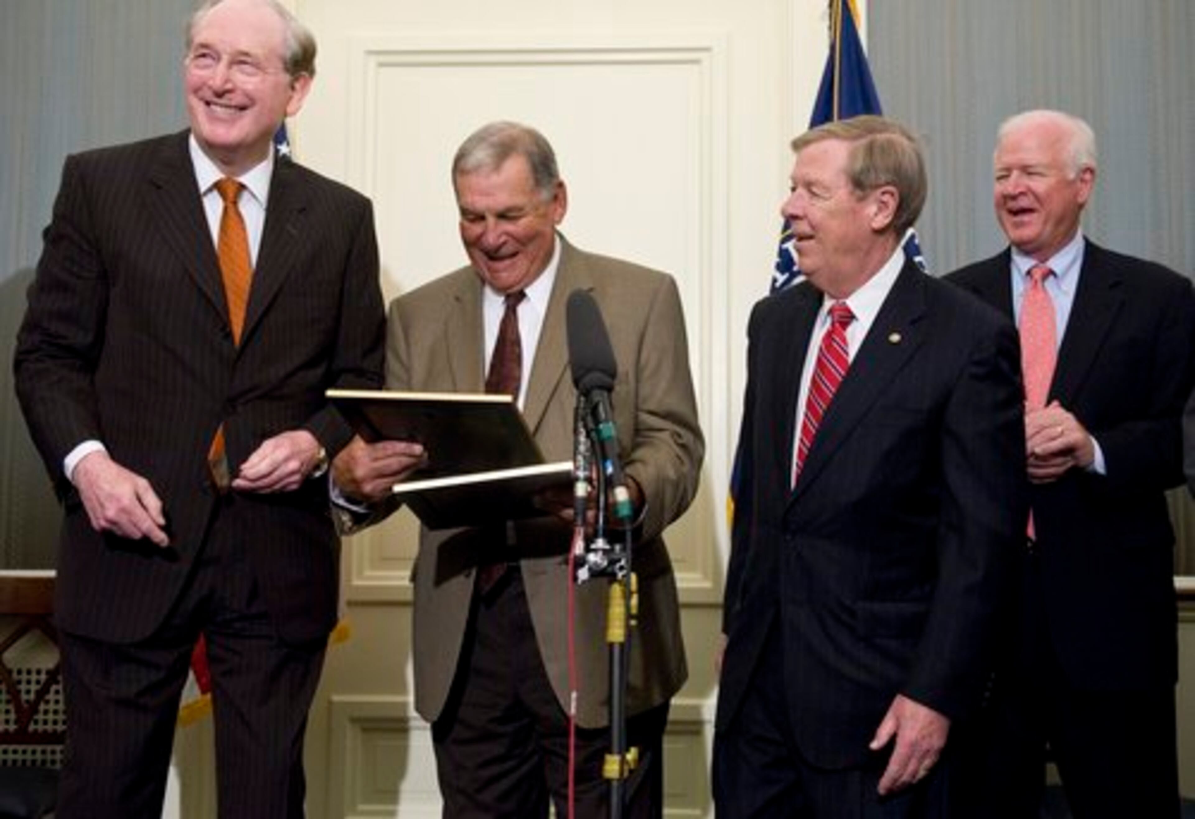 Rockefeller, Cox, Isakson and Chambliss smile during the ceremony.