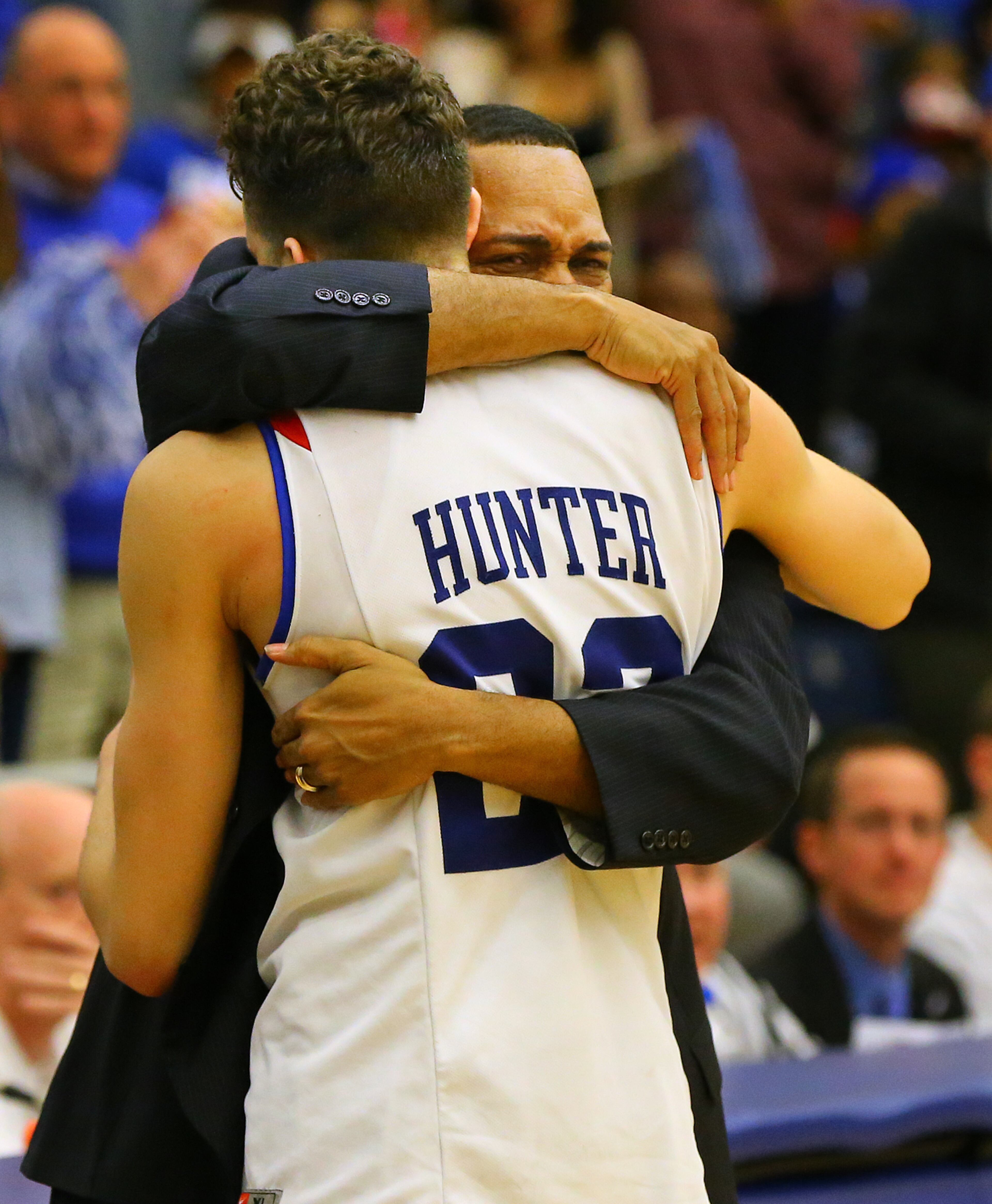 Georgia State head coach Ron Hunter embraces his son R.J. Hunter after winning the Sun Belt men's basketball regular season championship beating Georgia Southern 72-55 in a basketball game on Saturday, March 7, 2015, in Atlanta.