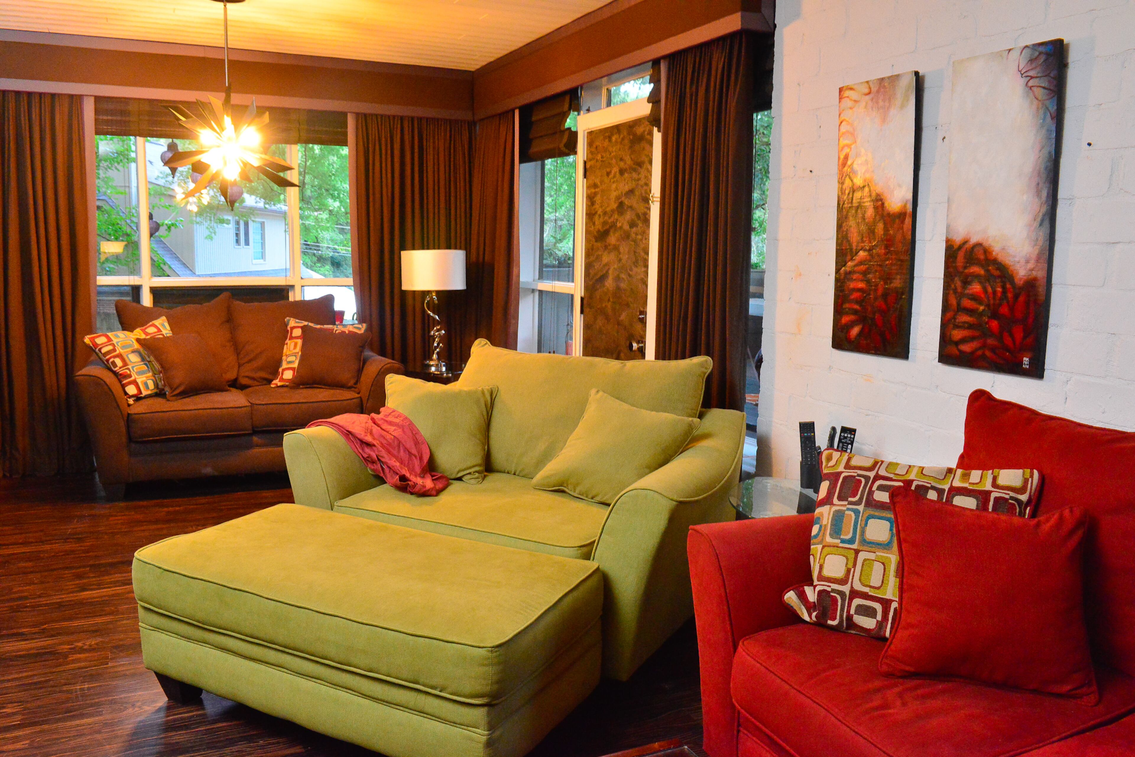 Furniture from Rooms to Go injects more color into the basement living area of the split-level ranch home and provides comfortable seating for TV watching. The chocolate drapes with purple trim were among the window treatments that the previous owner left in the home. The diptych piece, called "Love Plant," is by Amy Mann, a friend and former Atlanta Rollergirls teammate of Madeira.