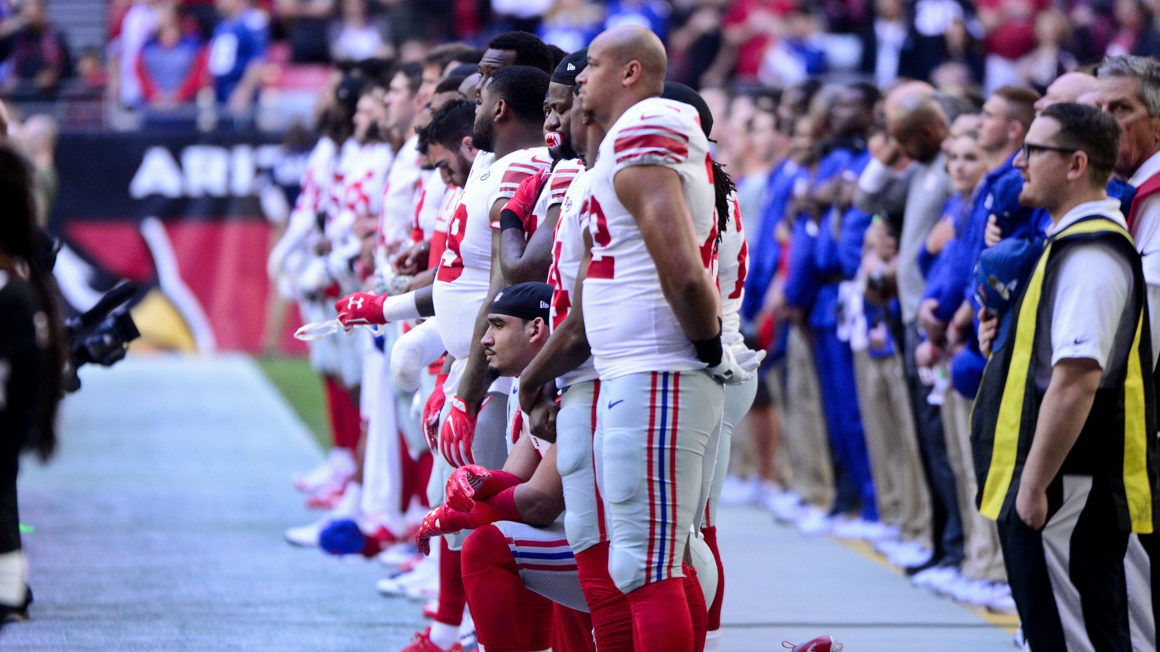 New York Giants defensive end Olivier Vernon (54) kneels during the National Anthem prior to the game against the Arizona Cardinals at University of Phoenix Stadium.
