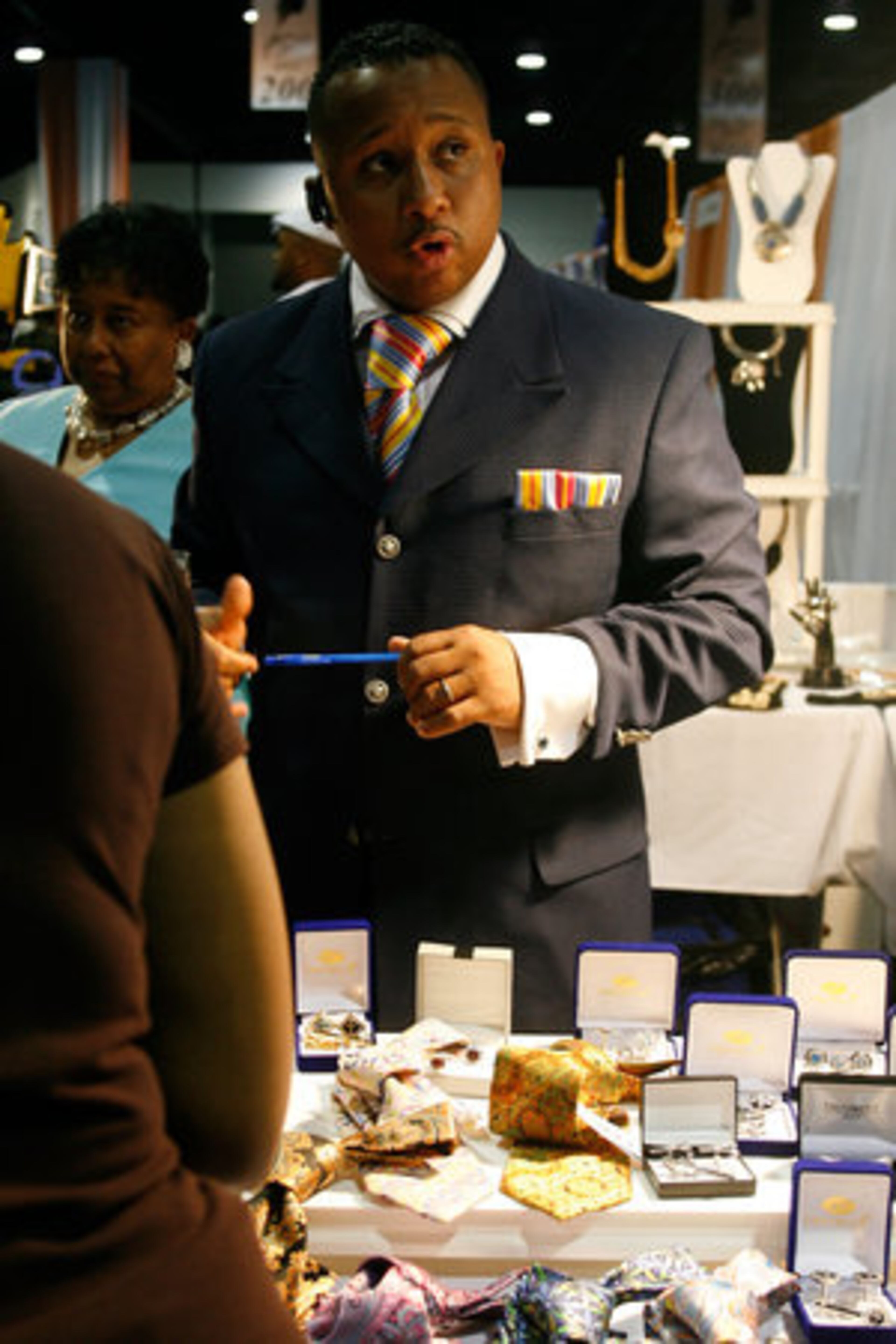 Thomas Sawyer of Raleigh suggests a neck tie for a customer.