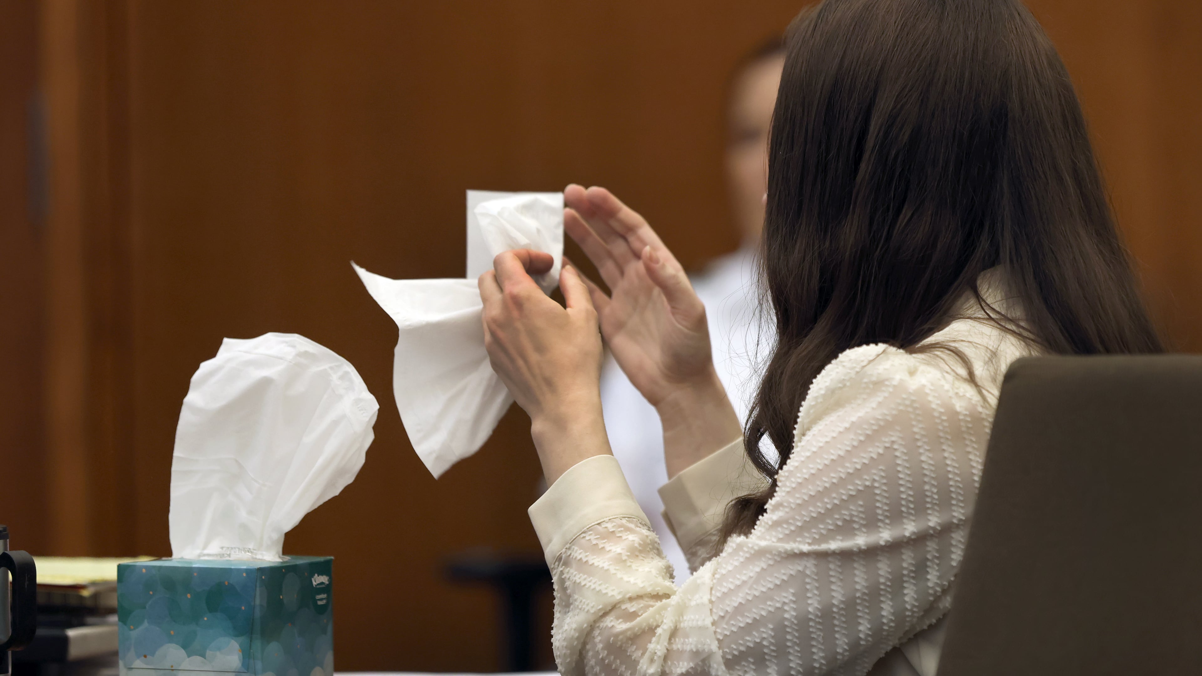 Lindsay Clancy grabs a tissue after witness Elaine Rossi, the nanny to the Clancy children, testified during her murder trial at Plymouth Superior Court in Plymouth, Mass., Wednesday, Aug. 5, 2026. (David L Ryan/The Boston Globe via AP, Pool) CORRECTION: Source is The Boston Globe, not The Boston Herald.