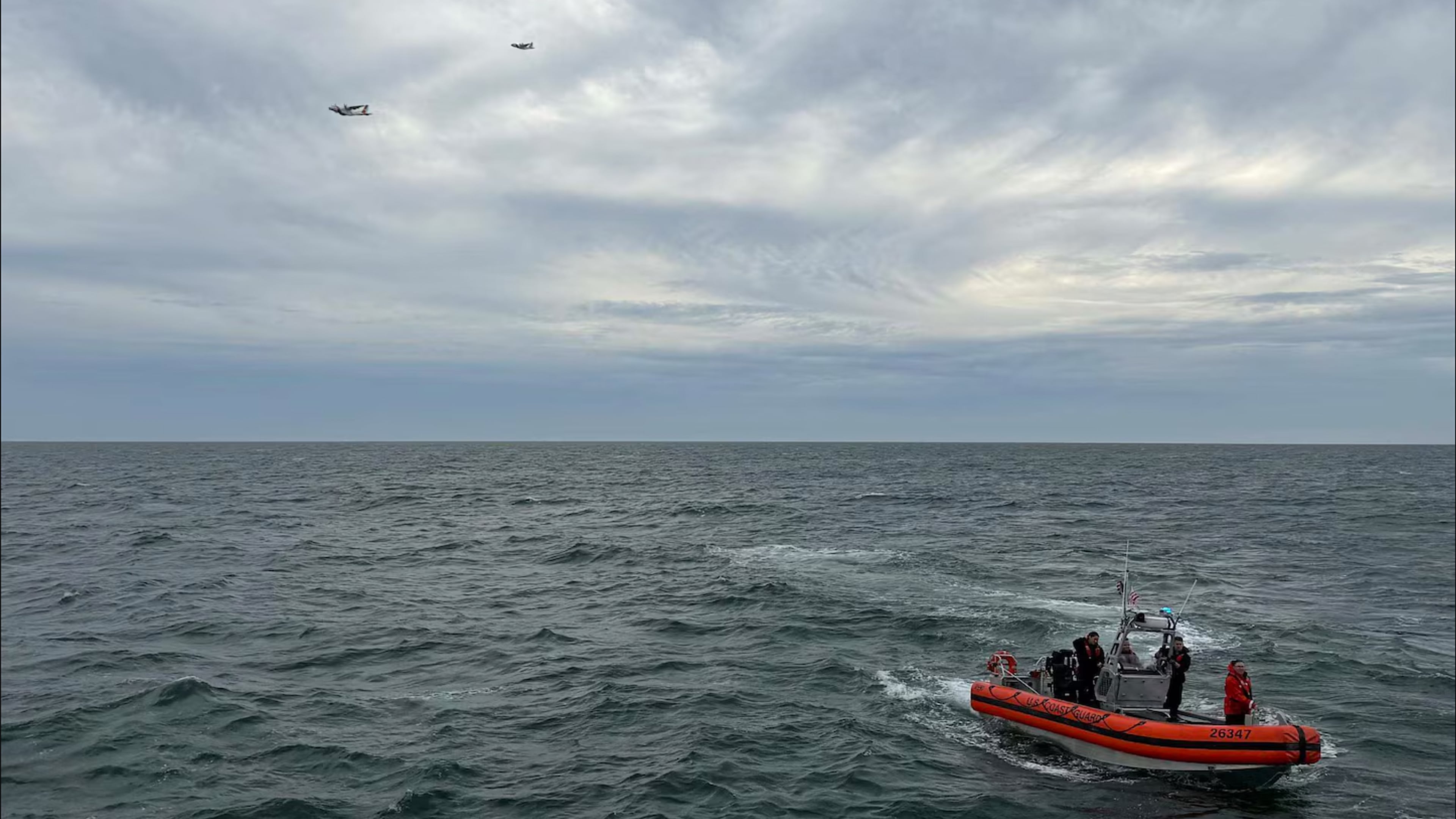 In this photo released by U.S. Coast Guard, crew members search by air and on the water for a Boston-bound air ambulance that vanished off the coast of Nantucket, Massachusetts, on Saturday, Oct. 3, 2026. (U.S. Coast Guard via AP)