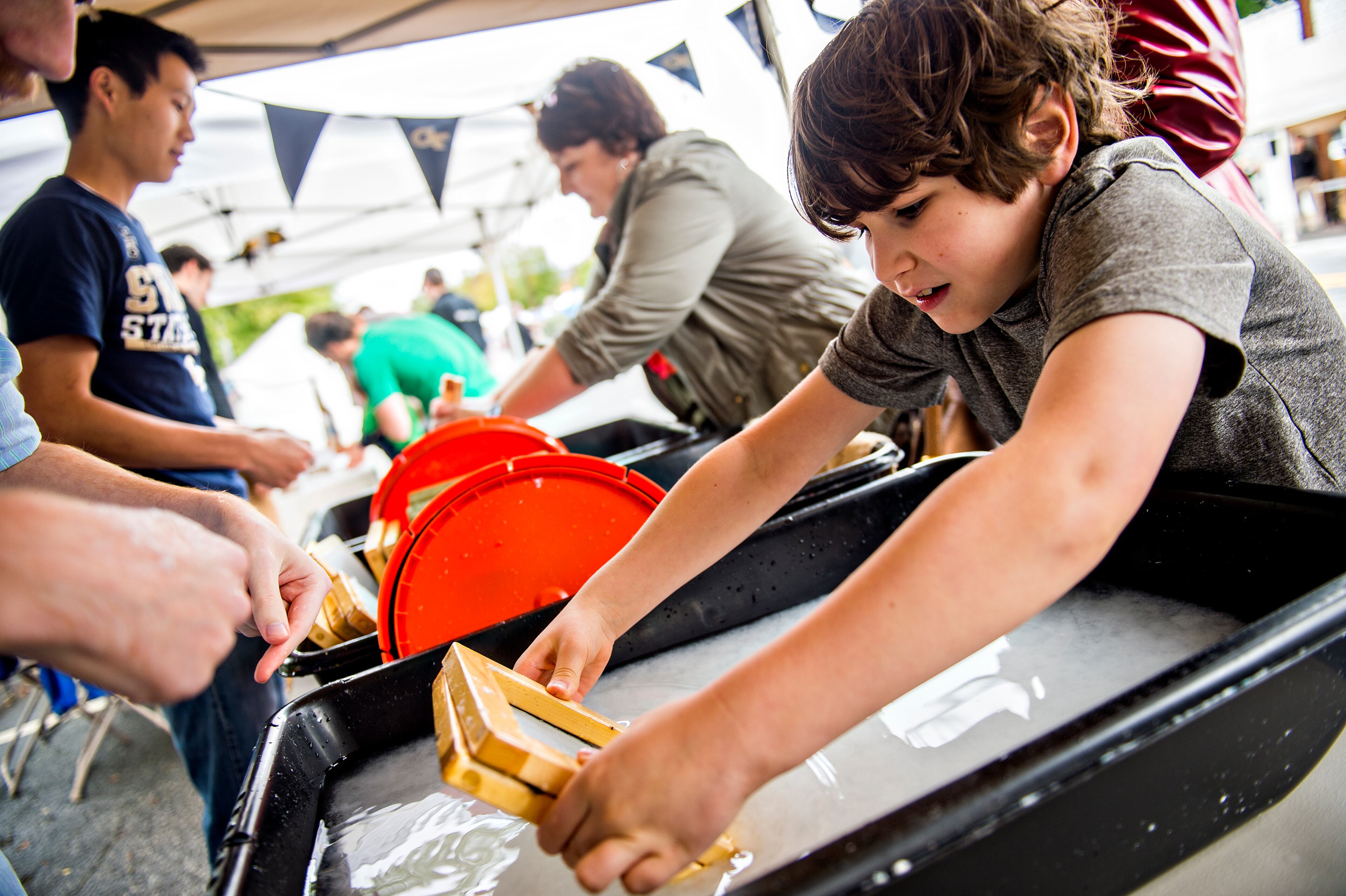 October 3, 2015 Decatur - Thomas Gaber - Kindt (right) makes his own sheet of paper during the Atlanta Maker Faire in Decatur on Saturday, October 3, 2015. The fair showcased invention, creativity and resourcefulness from tech enthusiasts, crafters, homesteaders, scientists and garage tinkerers. JONATHAN PHILLIPS / SPECIAL