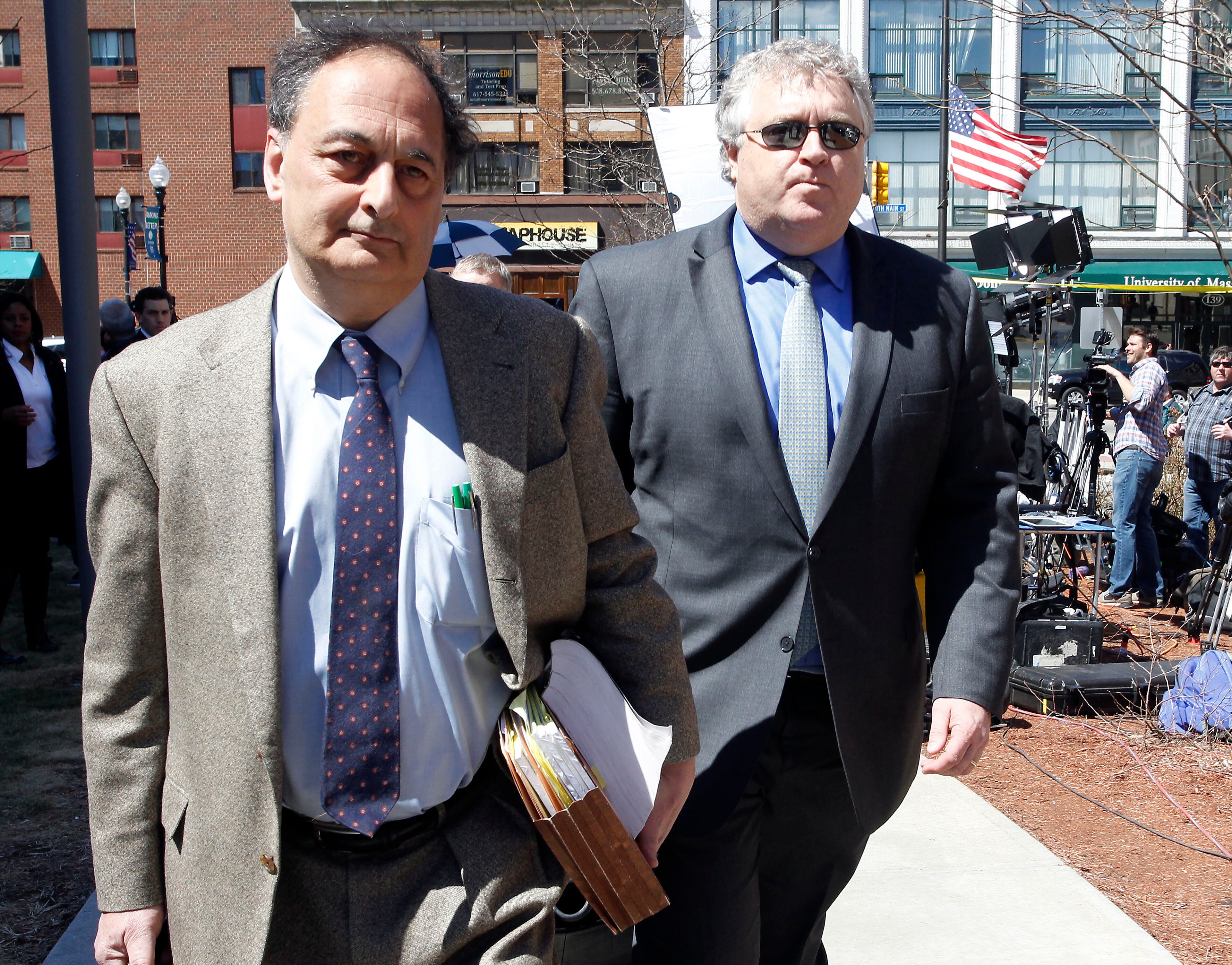 Defense attorneys James Sultan, left, and Michael Fee, right, leave Bristol County Superior Court, Wednesday, April 15, 2015, in Fall River, Mass., after their client former New England Patriots NFL football player Aaron Hernandez was found guilty of murder in the shooting death of Odin Lloyd. (AP Photo/Stew Milne)