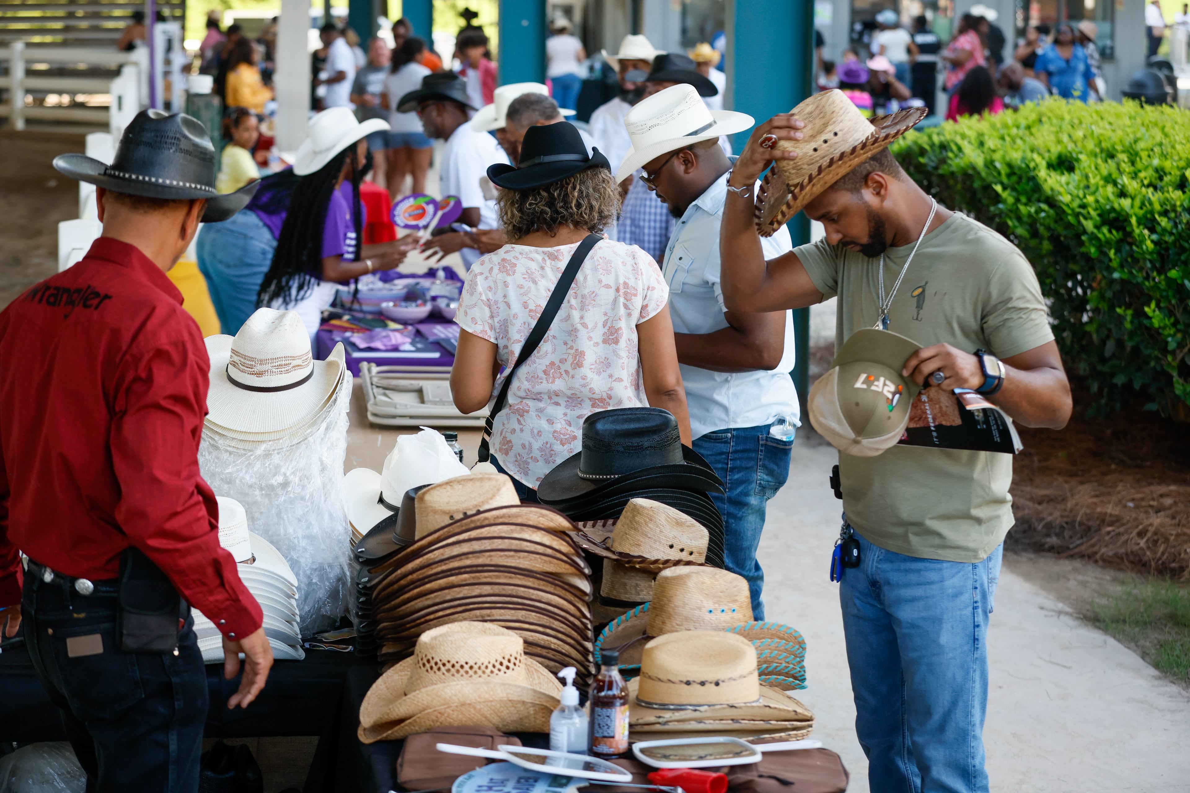 People look over the merchandise for sale before the start of the Bill Pickett Rodeo at the Georgia International Horse Park in Conyers on Saturday, August 6, 2022. The rodeo, which celebrates Black cowboys and cowgirls, saw its metro Atlanta two-day stop sell out. (Photo: Steve Schaefer / steve.schaefer@ajc.com)