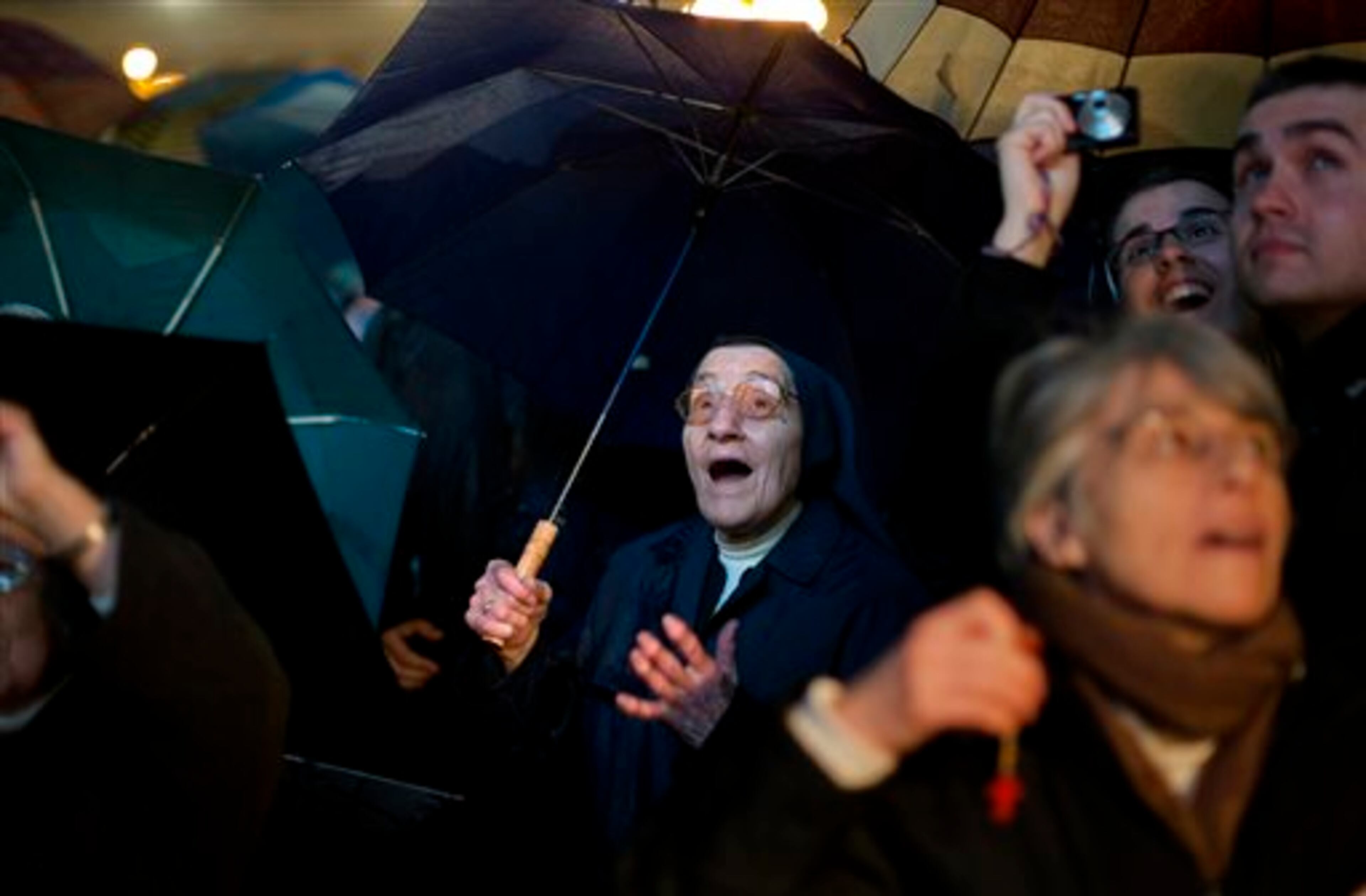 FILE - A nun reacts after white smoke billowed from the chimney on the Sistine Chapel indicating that a new pope has been elected in St. Peter's Square at the Vatican, Wednesday, March 13, 2013. Argentine Cardinal Jorge Bergoglio, who chose the name of Pope Francis, is the 266th pontiff of the Roman Catholic Church. This image was chosen by the Associated Press as one of the top 10 news photos representing the top stories of 2013. (AP Photo/Emilio Morenatti, File)