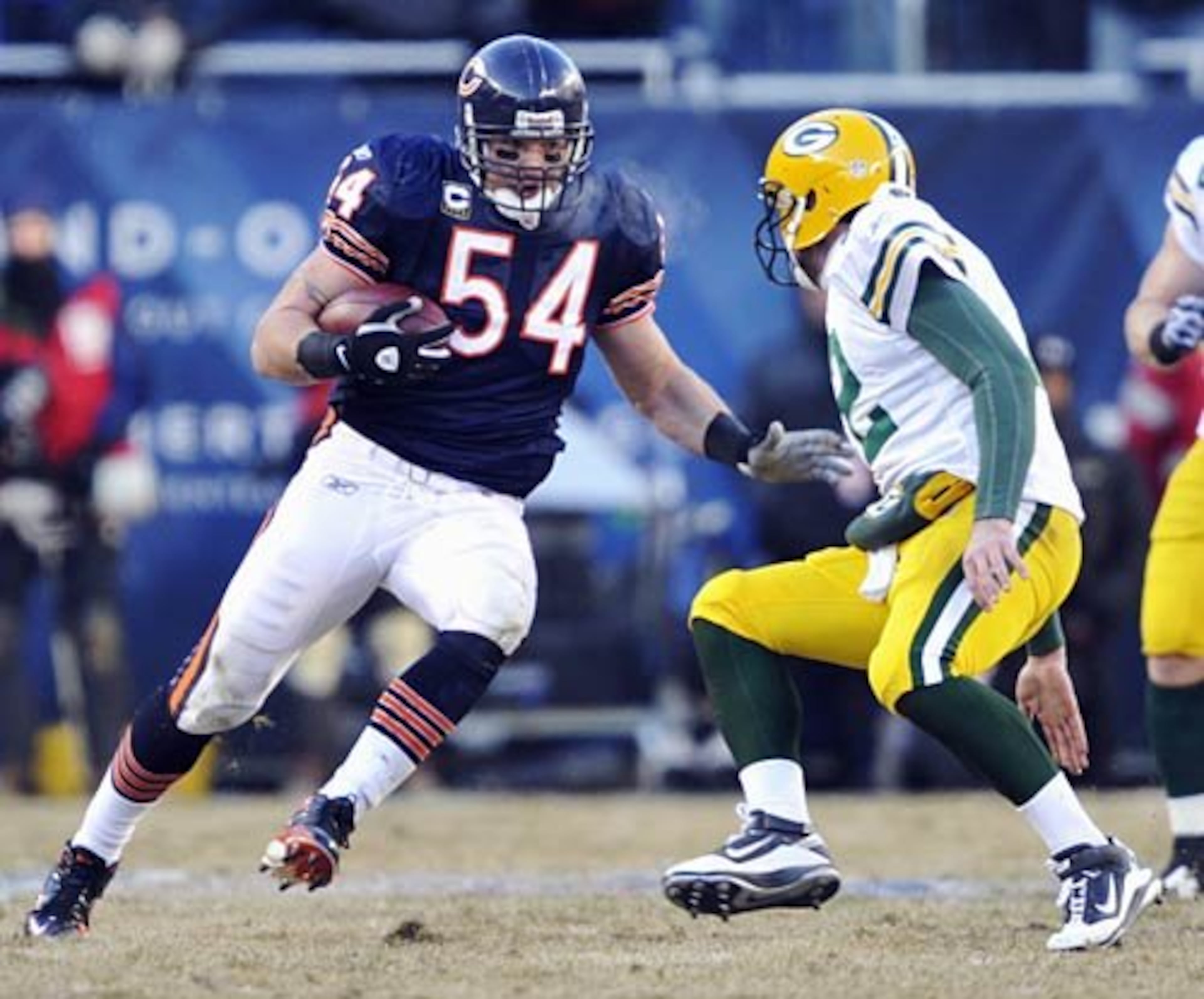 Bears linebacker Brian Urlacher (54) tries to run past Green Bay Packers quarterback Aaron Rodgers (12) runs after intercepting a pass by Rodgers in the second half of the NFC Championship.