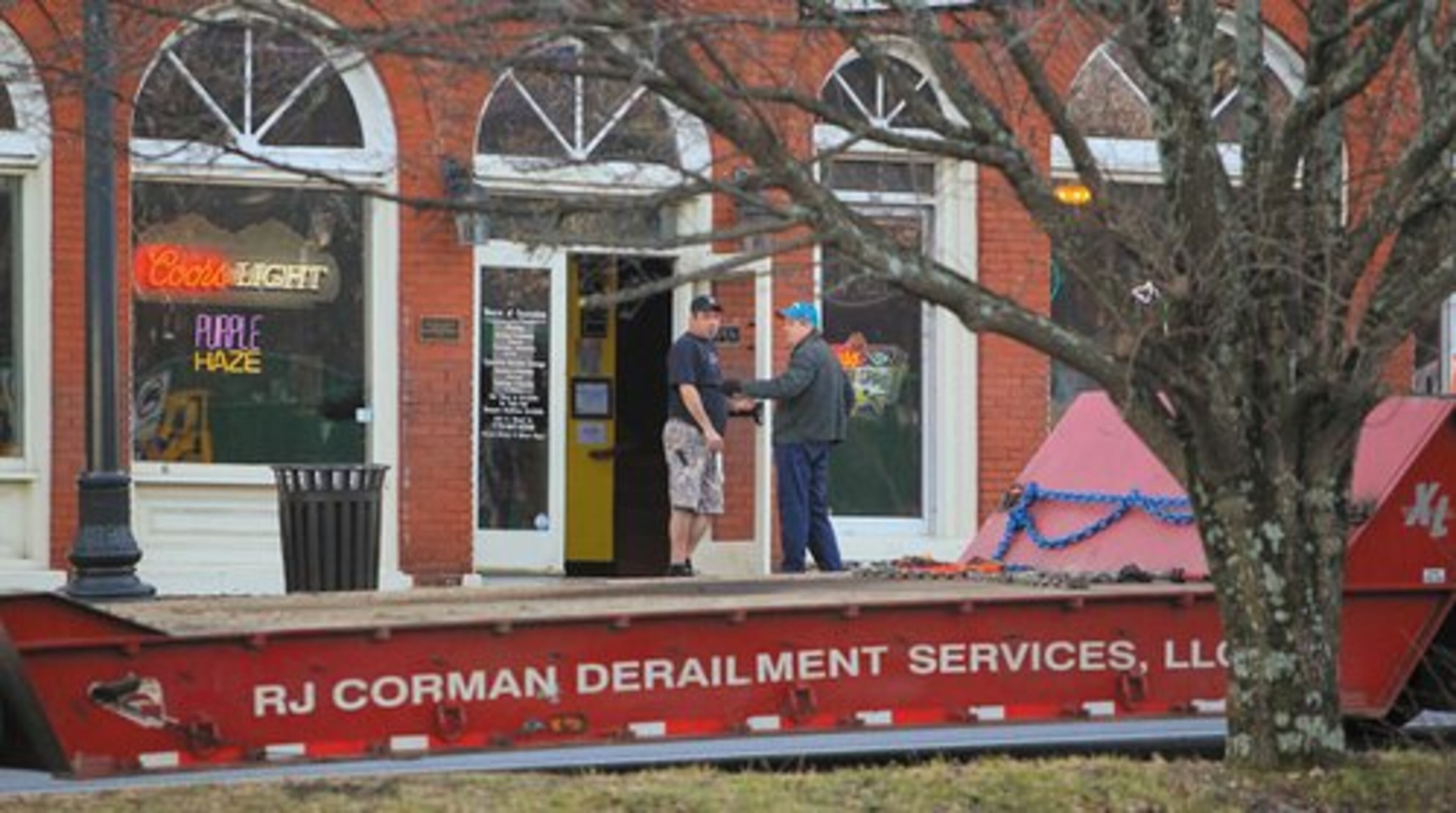 Merchants in Douglasville in front of Gumbeaux's talk as a derailment trailer is parked in front of their businesses.