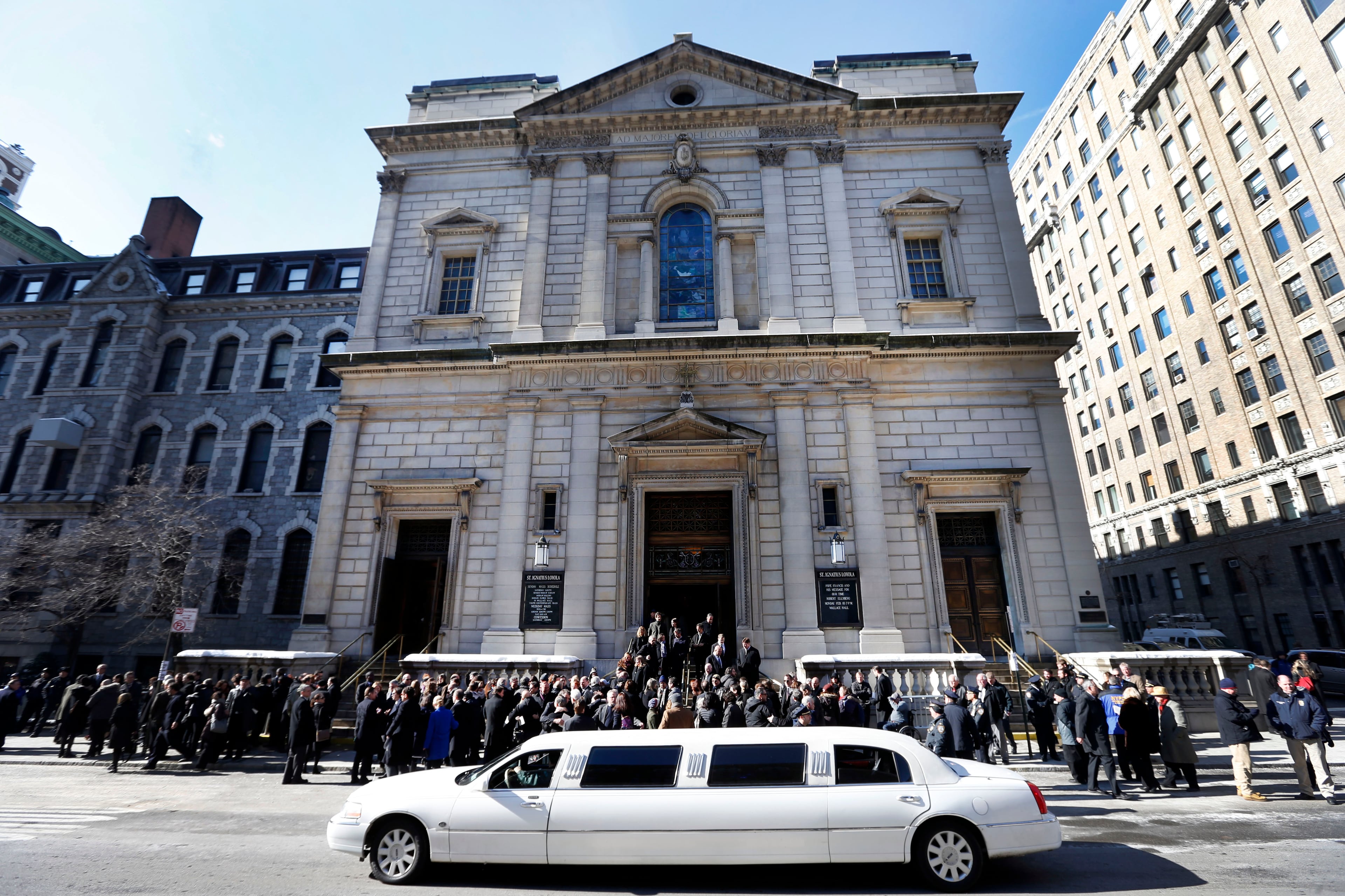 Mourners congregate outside the Church of St. Ingatius Loyola following the funeral of actor Philip Seymour Hoffman Friday, Feb. 7, 2014, in New York. Hoffman, 46, was found dead Sunday of an apparent heroin overdose. (AP Photo/Jason DeCrow)