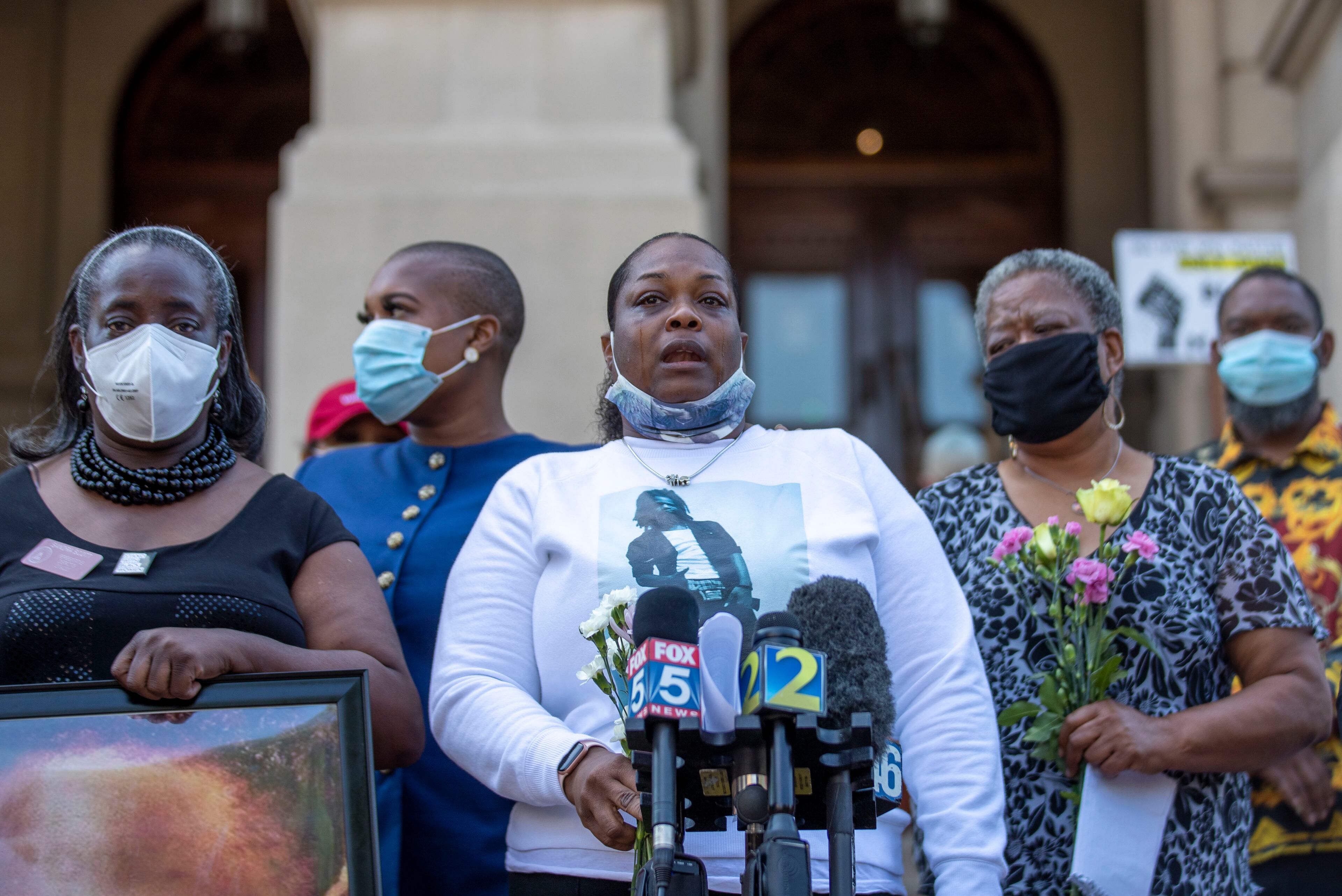 06/02/2020 - Atlanta, Georgia - Georgia State Rep. Sandra Scott (D-Rex) holds a photo of Jabril Robinson as his mother, Dalphine Robinson (center), speaks on his behalf during a press conference on the steps of the Georgia State Capitol Building in Atlanta, Tuesday, June 2, 2020. State investigators found Clayton County police shot a Jabril, a 23-year-old man, multiple times, ultimately killing him when the man ran from and aimed a gun at them in 2016. The press conference was hosted by several local Democratic legislatures who were showing support for mother's who that are seeking justice for the deaths of their sons by police officers. (ALYSSA POINTER / ALYSSA.POINTER@AJC.COM)