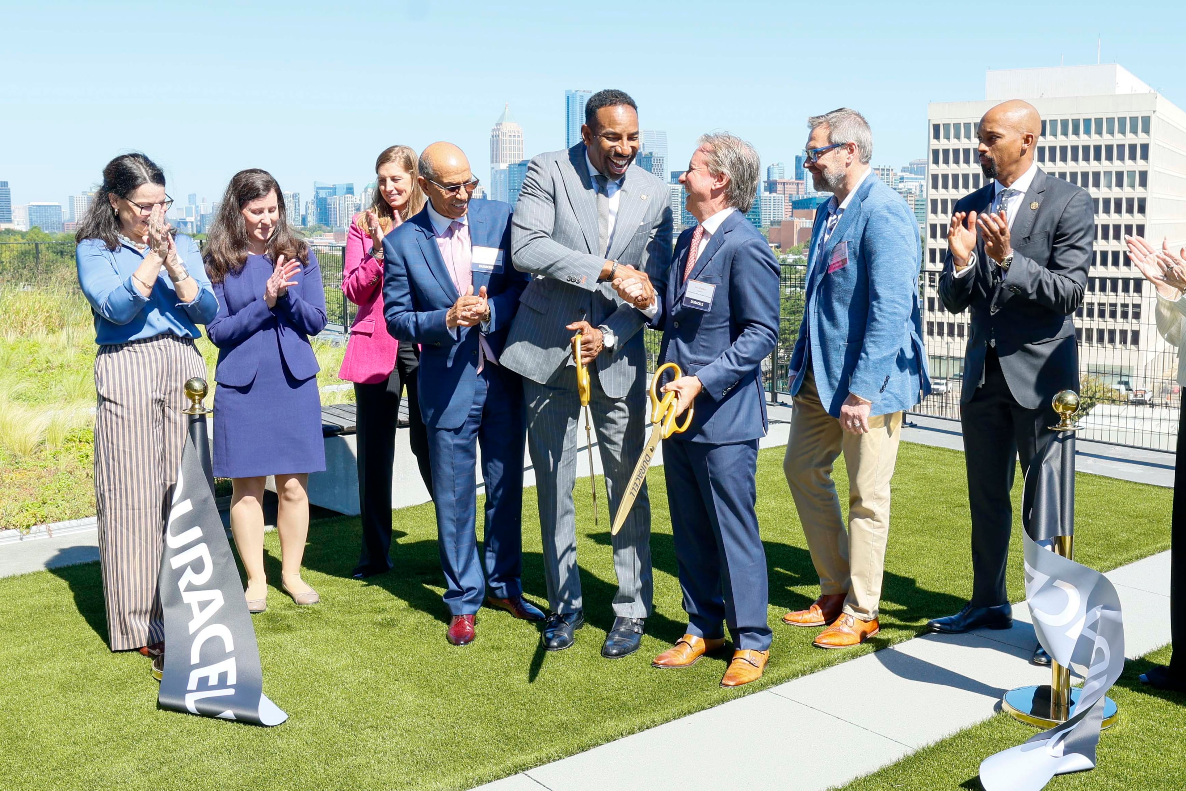 Atlanta Mayor Andre Dickens (center) shakes hands with Duracell CEO Roberto Mendez on Tuesday, Oct. 6, 2026, after the ribbon-cutting ceremony for the new Duracell global research and development hub at Science Square in Atlanta. (Miguel Martinez/AJC)